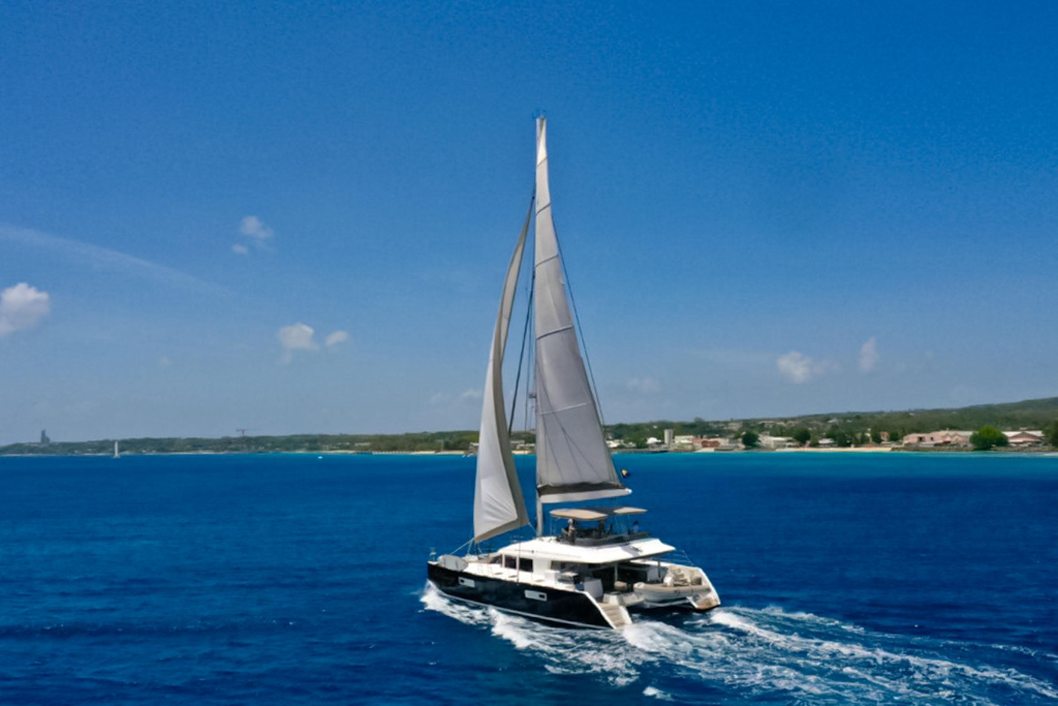 Lagoon-560 S2 2015-Cool Runnings IV SC-US-2015 Lagoon 560 S2 sailing catamaran on open blue sea under clear sky.-9782915 | Thumbnail