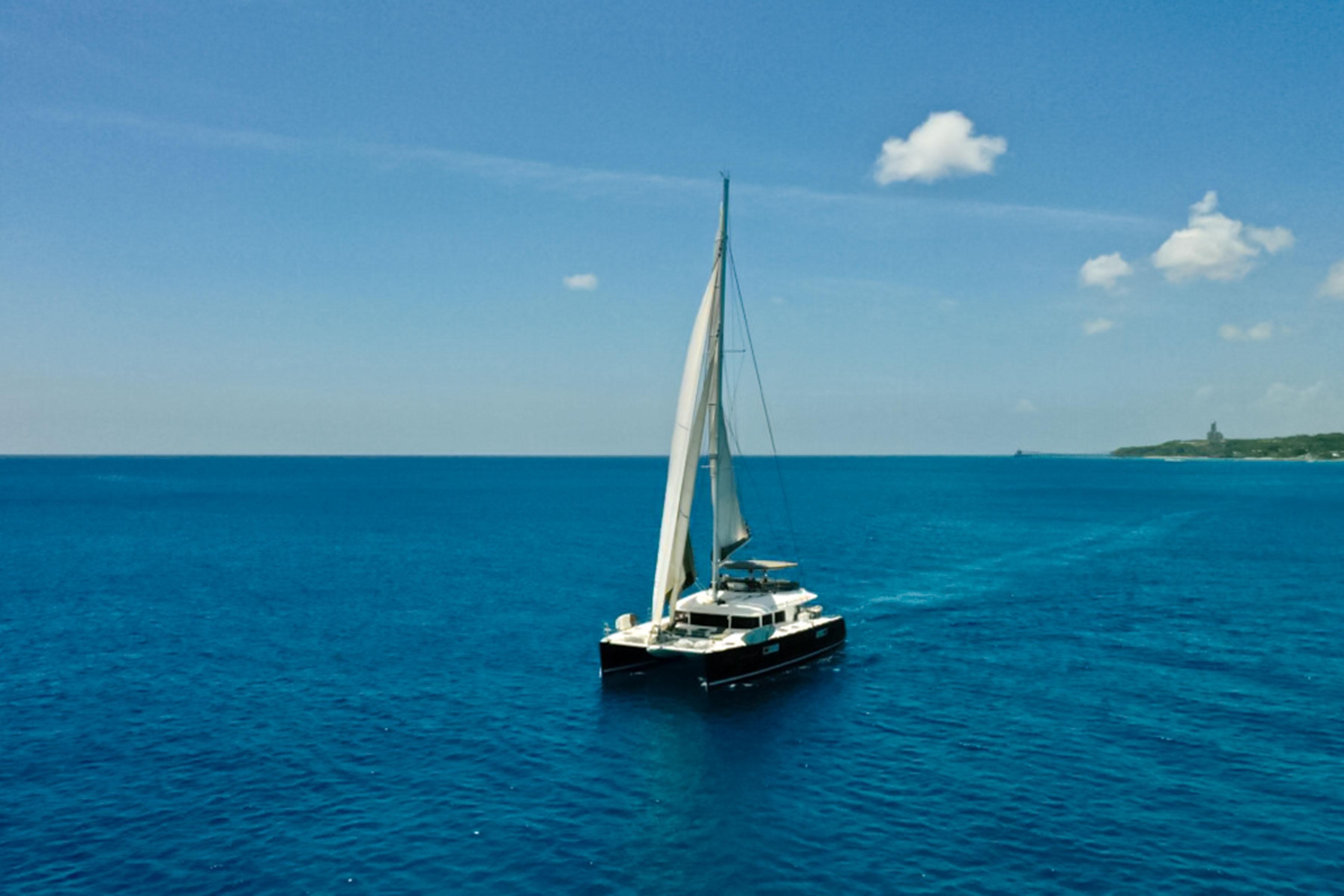 Lagoon-560 S2 2015-Cool Runnings IV SC-US-Sailing Lagoon 560 S2 catamaran on open sea under clear blue sky.-9782915 | Thumbnail