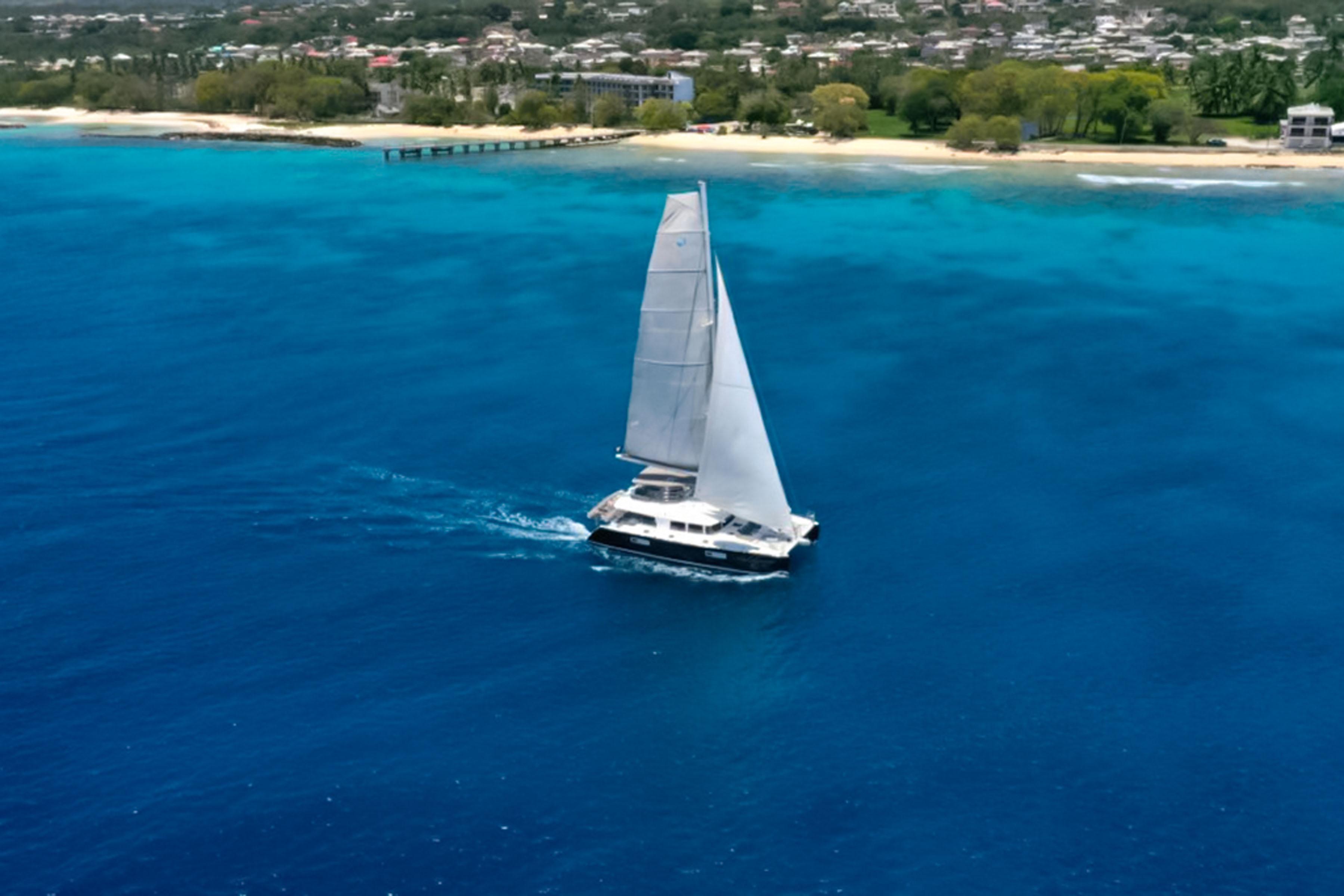 Lagoon-560 S2 2015-Cool Runnings IV SC-US-Lagoon 560 S2 sailing near a tropical coastline, 2015 model.-9782915 | Thumbnail