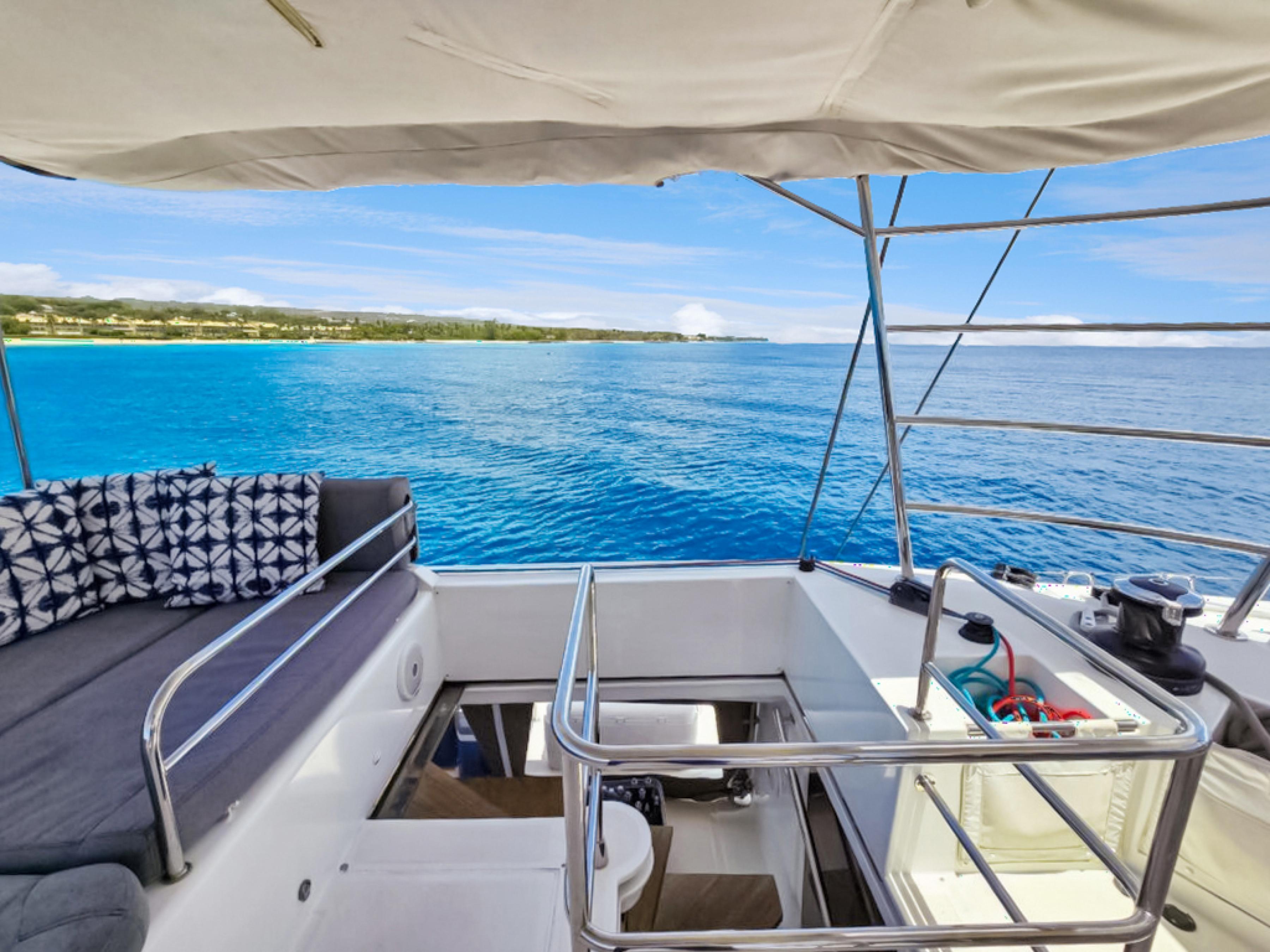 Lagoon-560 S2 2015-Cool Runnings IV SC-US-Lagoon 560 S2 yacht interior with ocean view, featuring comfortable seating and clear blue waters.-9782915 | Thumbnail