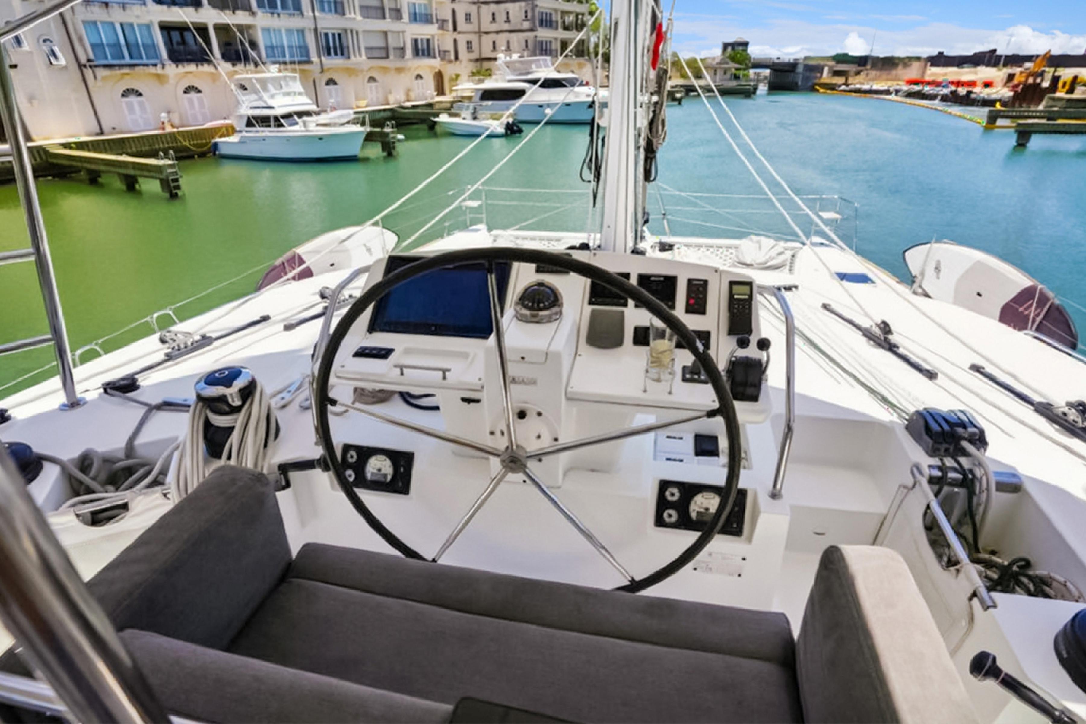 Lagoon-560 S2 2015-Cool Runnings IV SC-US-Helm of 2015 Lagoon 560 S2 yacht in marina, featuring modern navigation controls.-9782915 | Thumbnail