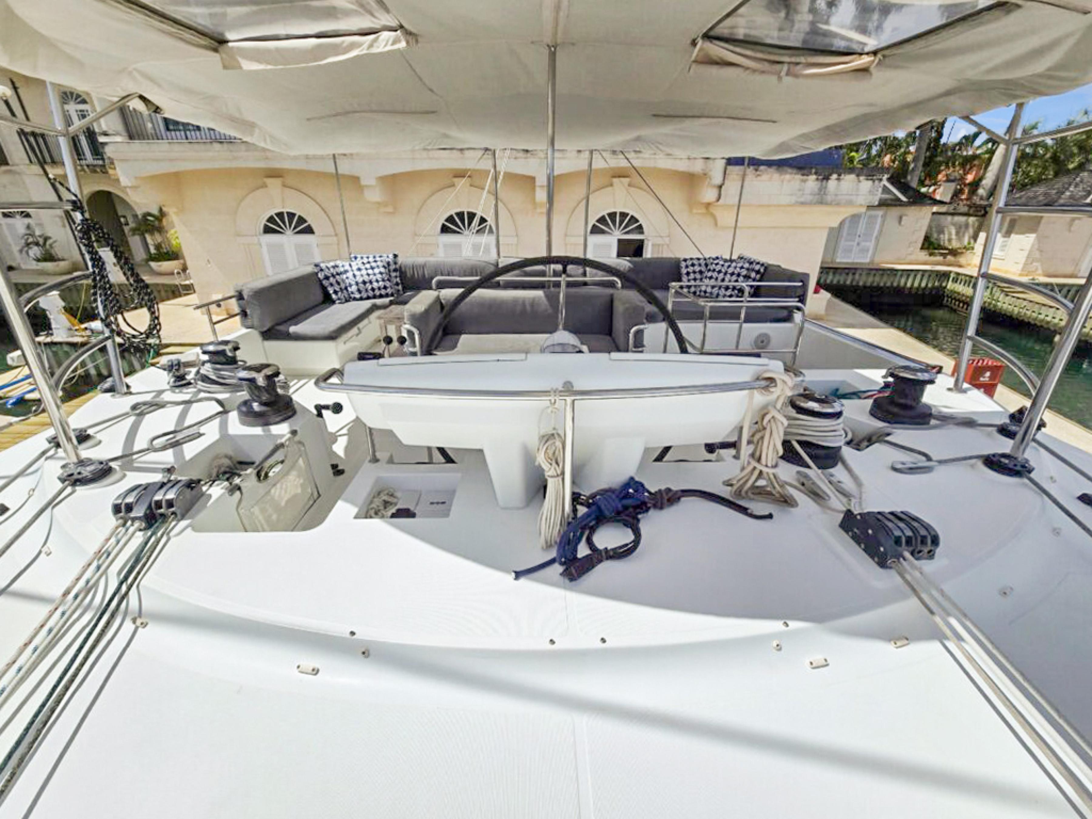 Lagoon-560 S2 2015-Cool Runnings IV SC-US-Lagoon 560 S2 yacht deck, 2015 model, featuring spacious seating and steering area.-9782915 | Thumbnail