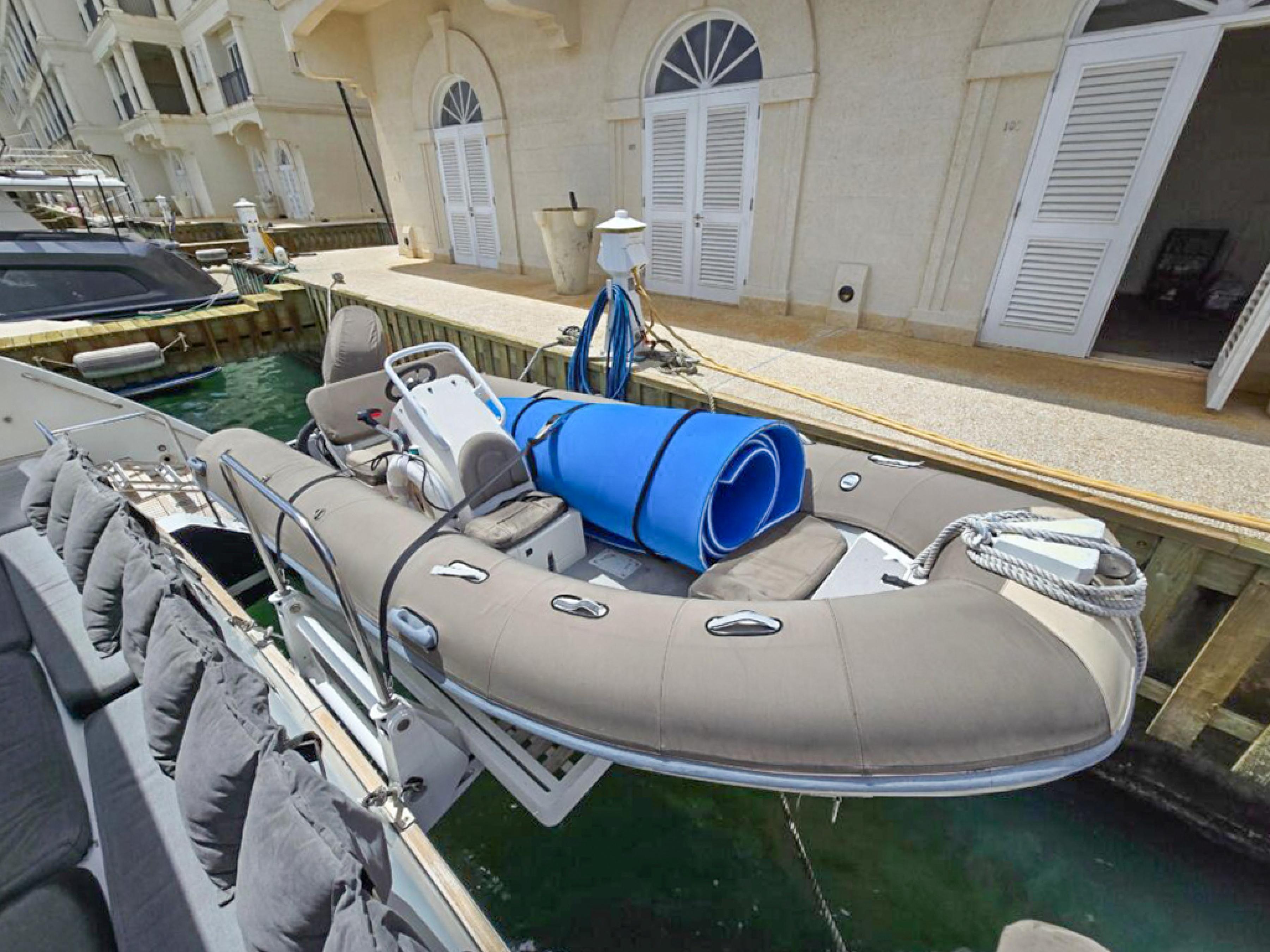 Lagoon-560 S2 2015-Cool Runnings IV SC-US-Inflatable boat docked beside a Lagoon 560 S2 yacht, 2015 model.-9782915 | Thumbnail