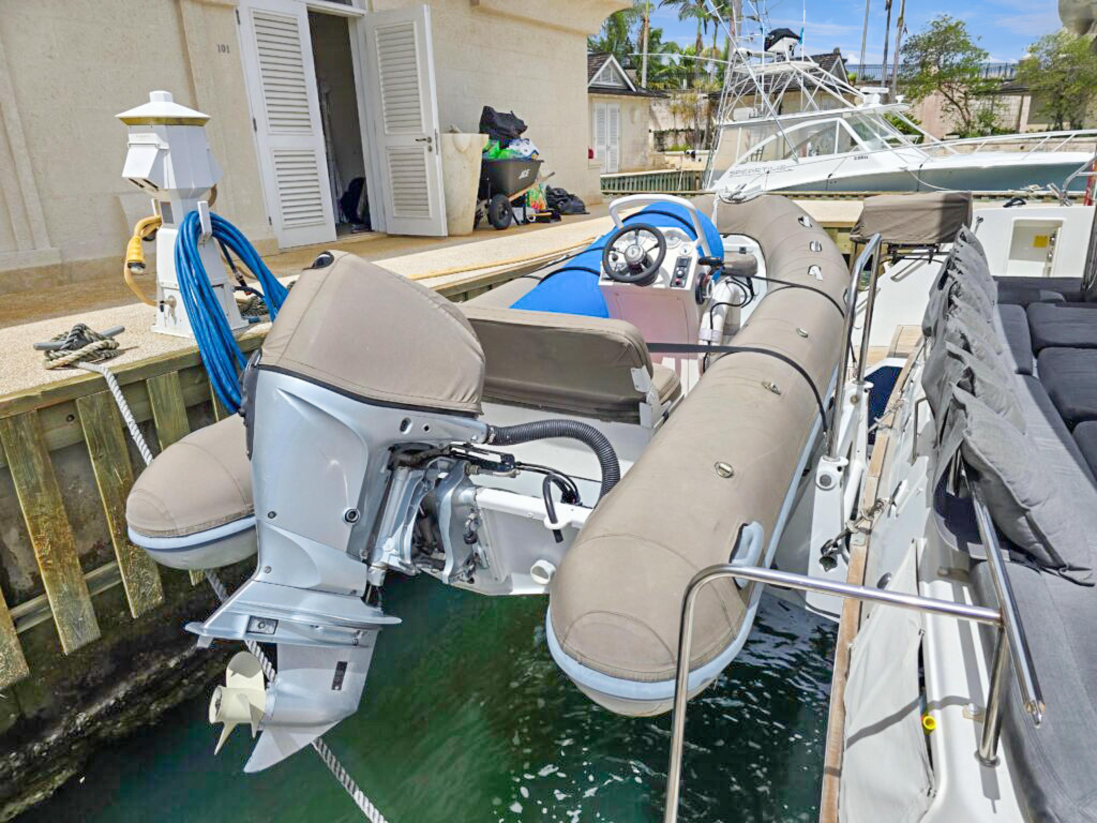 Lagoon-560 S2 2015-Cool Runnings IV SC-US-Inflatable boat docked beside a 2015 Lagoon 560 S2 yacht.-9782915 | Thumbnail