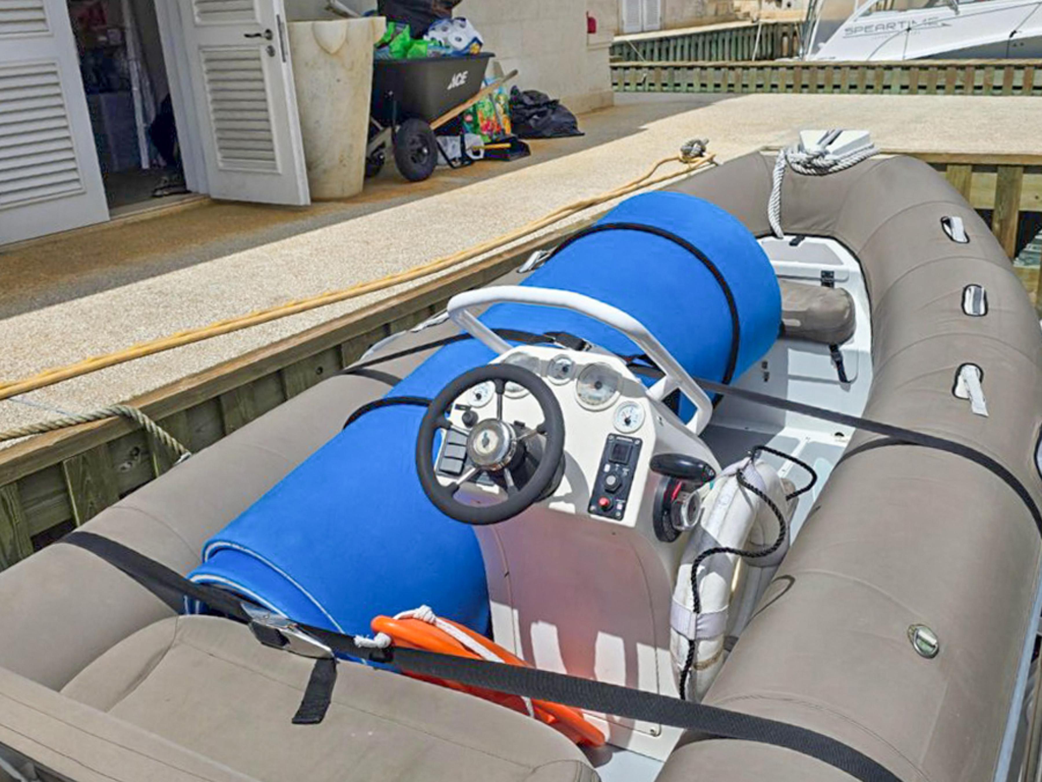 Lagoon-560 S2 2015-Cool Runnings IV SC-US-Inflatable boat docked, featuring steering console and blue equipment, near Lagoon 560 S2, 2015.-9782915 | Thumbnail