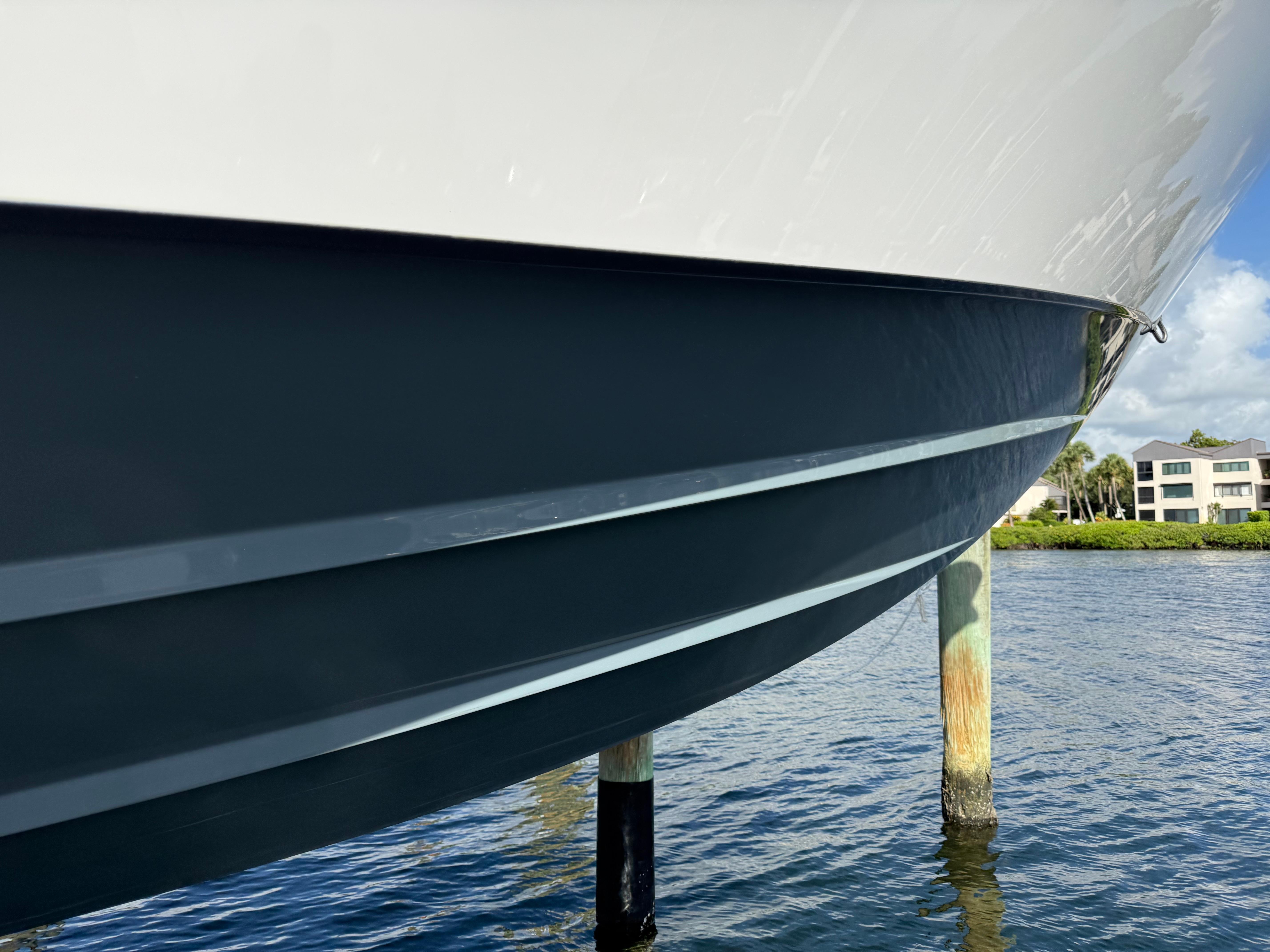 2022 Contender 39 ST boat hull in water, showcasing sleek design and craftsmanship.