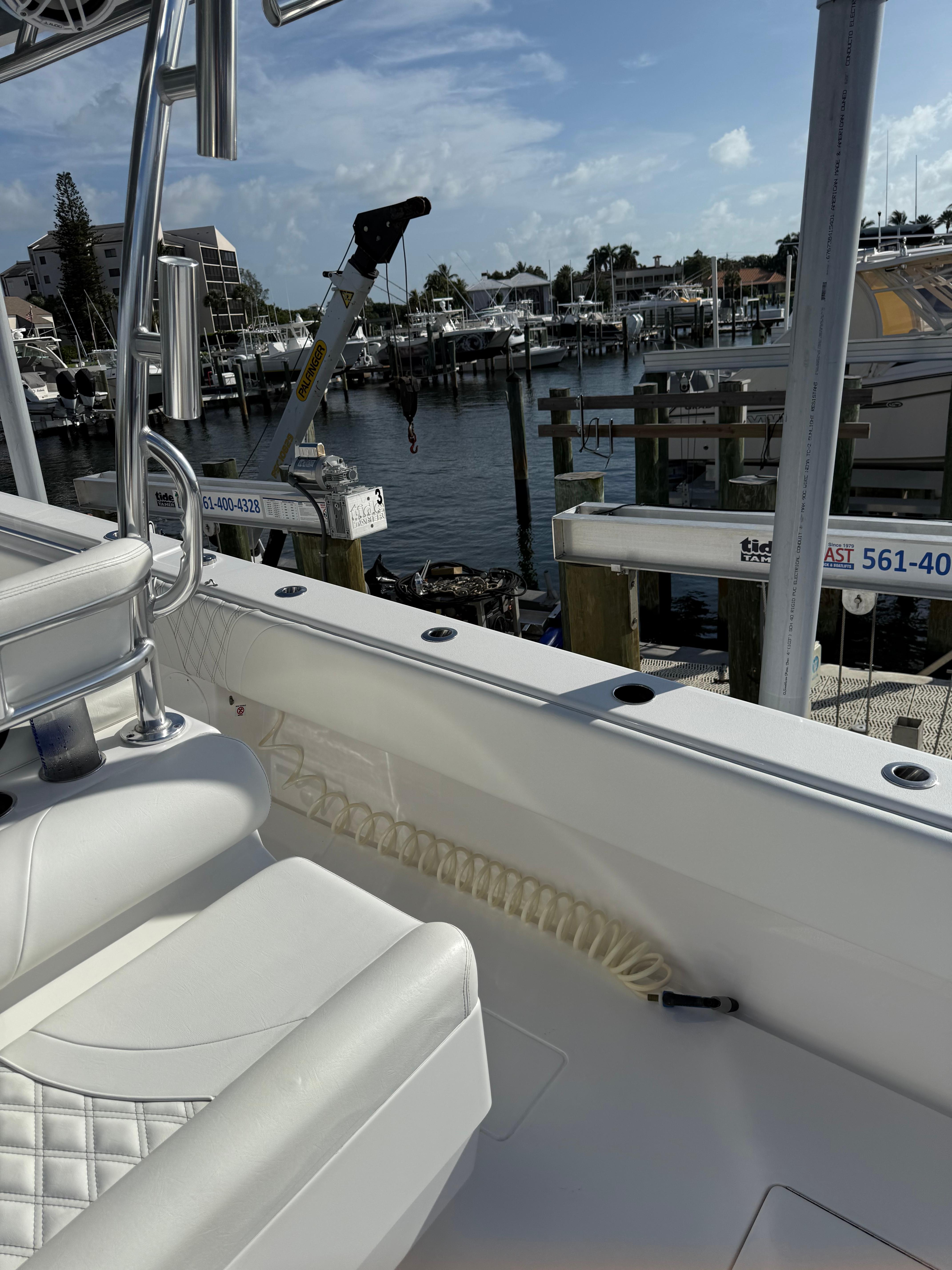 2022 Contender 39 ST boat docked at marina under clear blue sky.