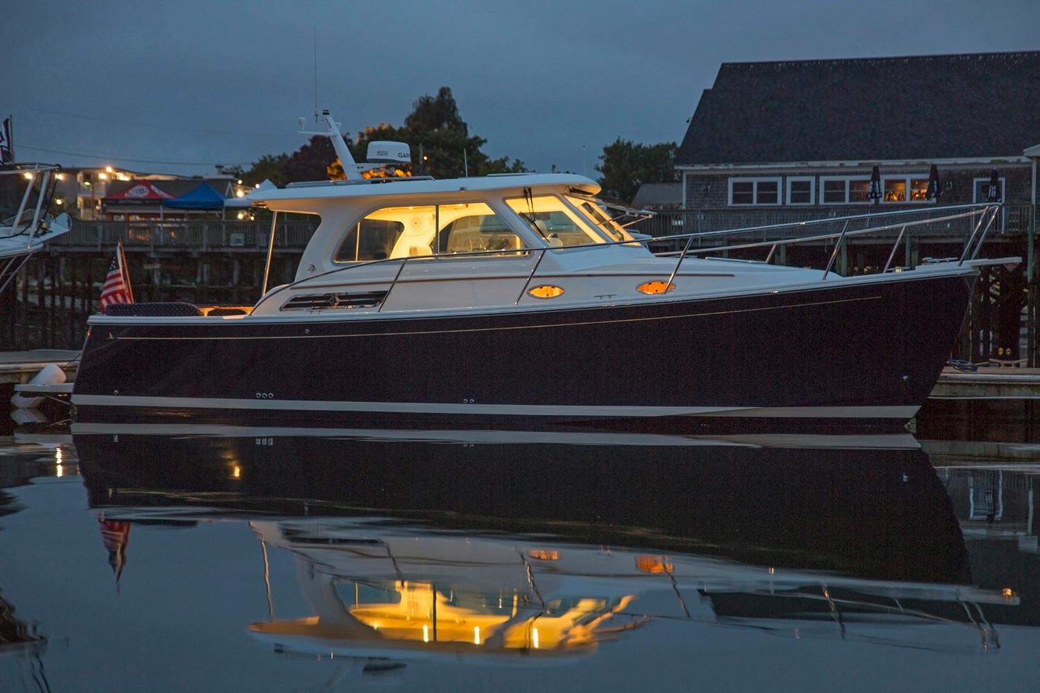 Manufacturer Provided Image: 2018 Back Cove 32 yacht docked at night with lights on.