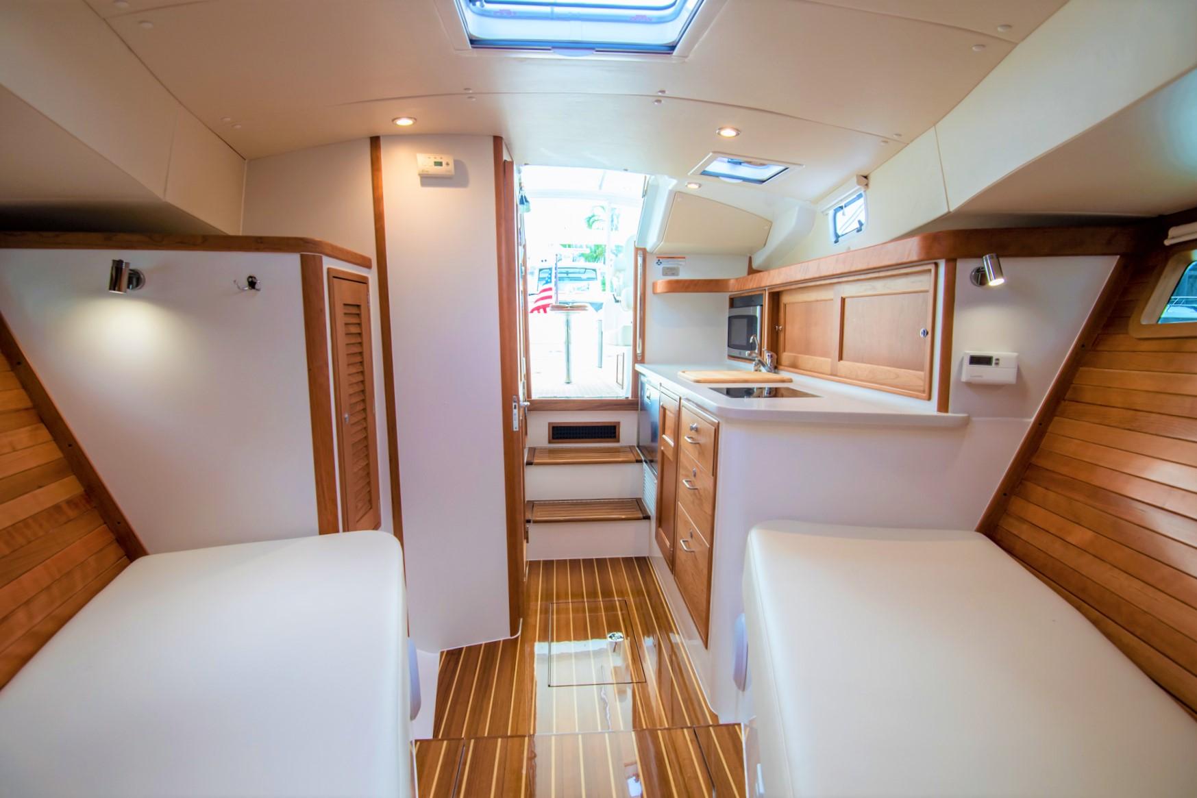 Interior of 2023 MJM 35 yacht with wooden accents and modern amenities.
