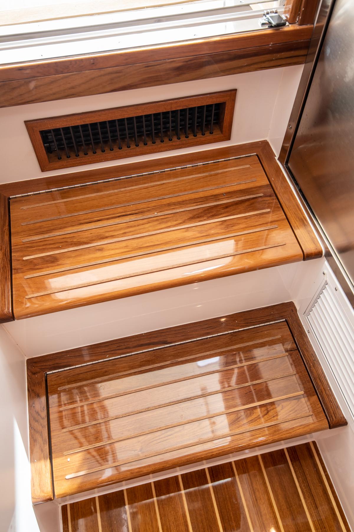 2023 MJM 35 yacht interior with polished wooden steps and vent.