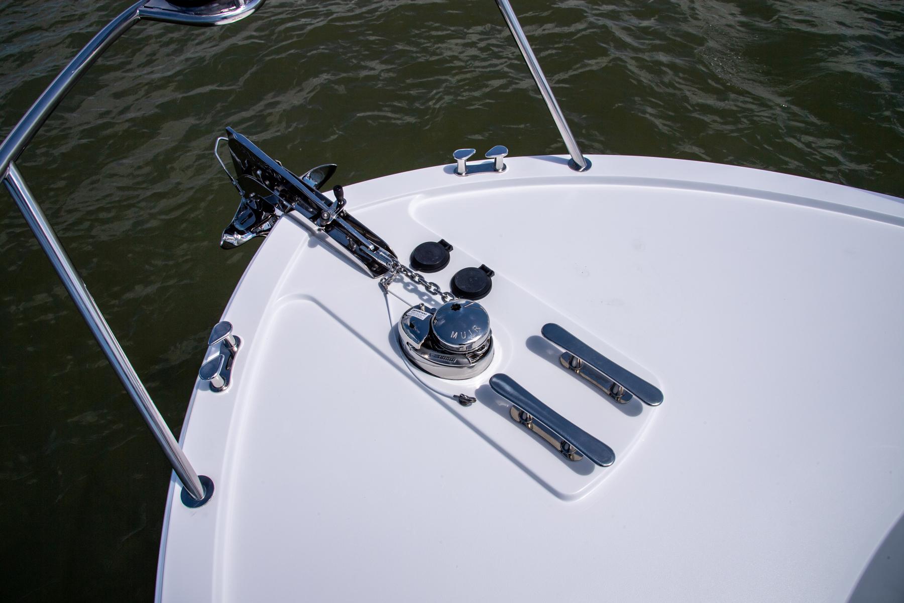 Bow of 2023 MJM 35 boat with anchor and cleats on water.