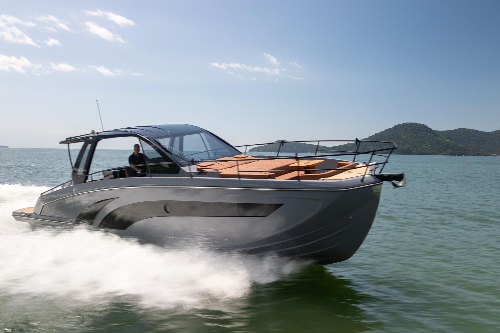 Modern Hanover 447 yacht cruising on open water, 2026 model, with scenic mountain backdrop.