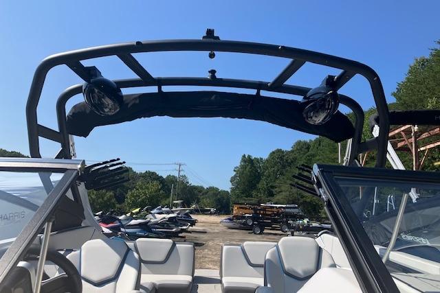 2021 Yamaha Boats 252XE interior with wakeboard tower and seating, parked outdoors.