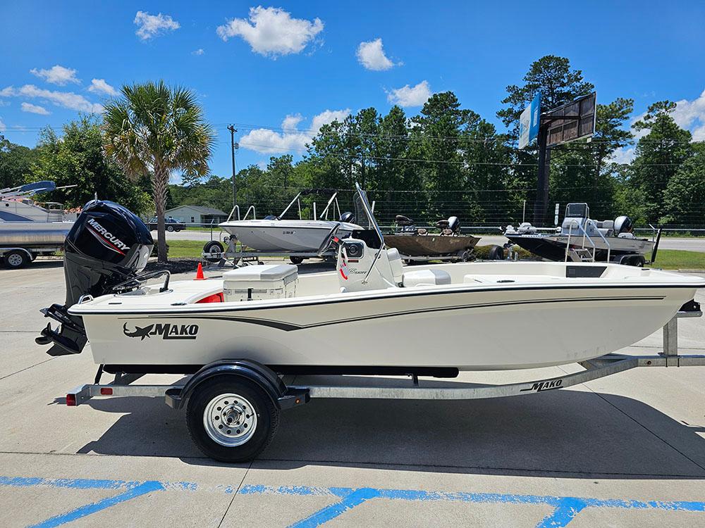 2025 Mako Pro Skiff 15 CC boat on trailer, parked outdoors under blue sky.