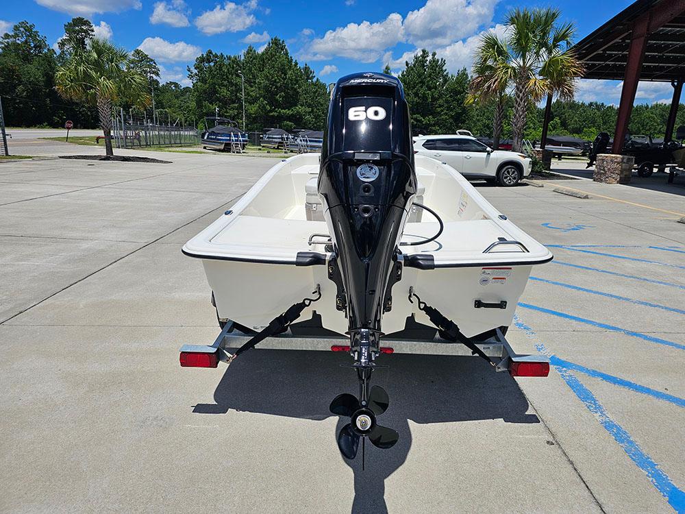 2025 Mako Pro Skiff 15 CC on trailer, parked outdoors under blue sky.