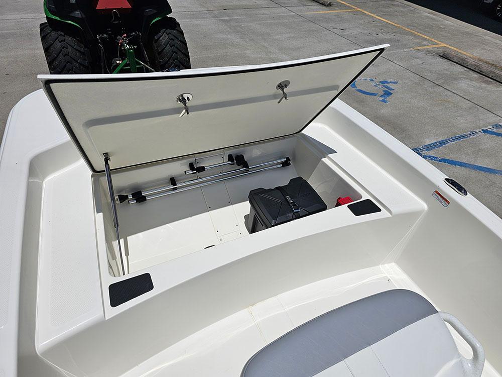 2025 Mako Pro Skiff 15 CC storage compartment open, showing interior space and equipment.