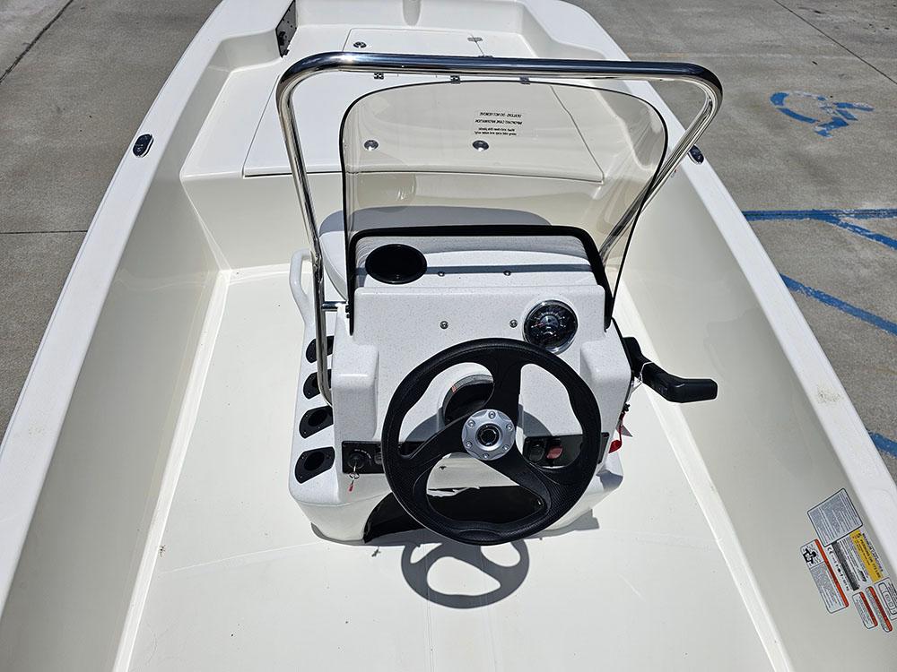 2025 Mako Pro Skiff 15 CC boat console with steering wheel and controls.