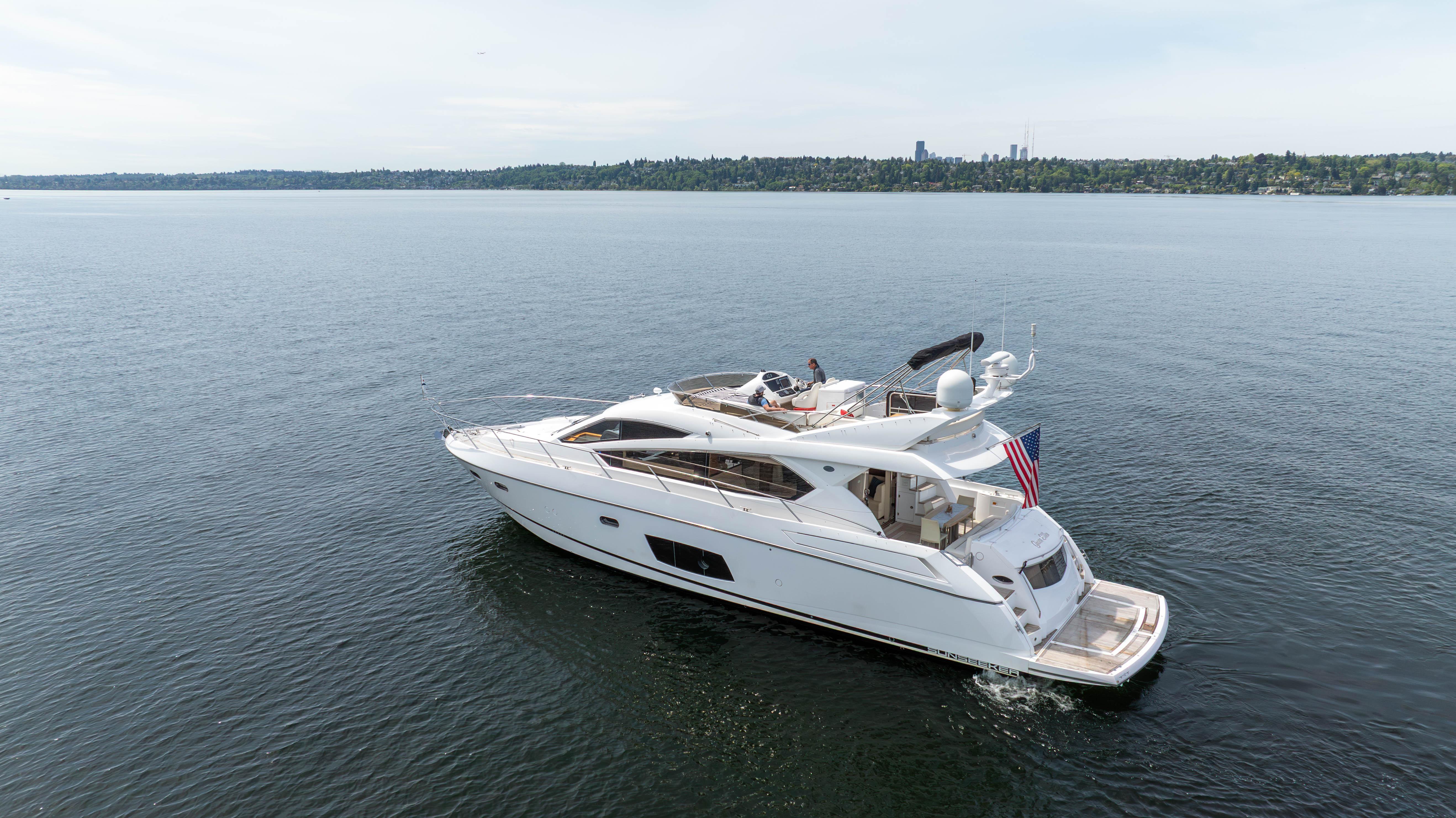2012 Sunseeker Manhattan 63 yacht cruising on a calm lake.
