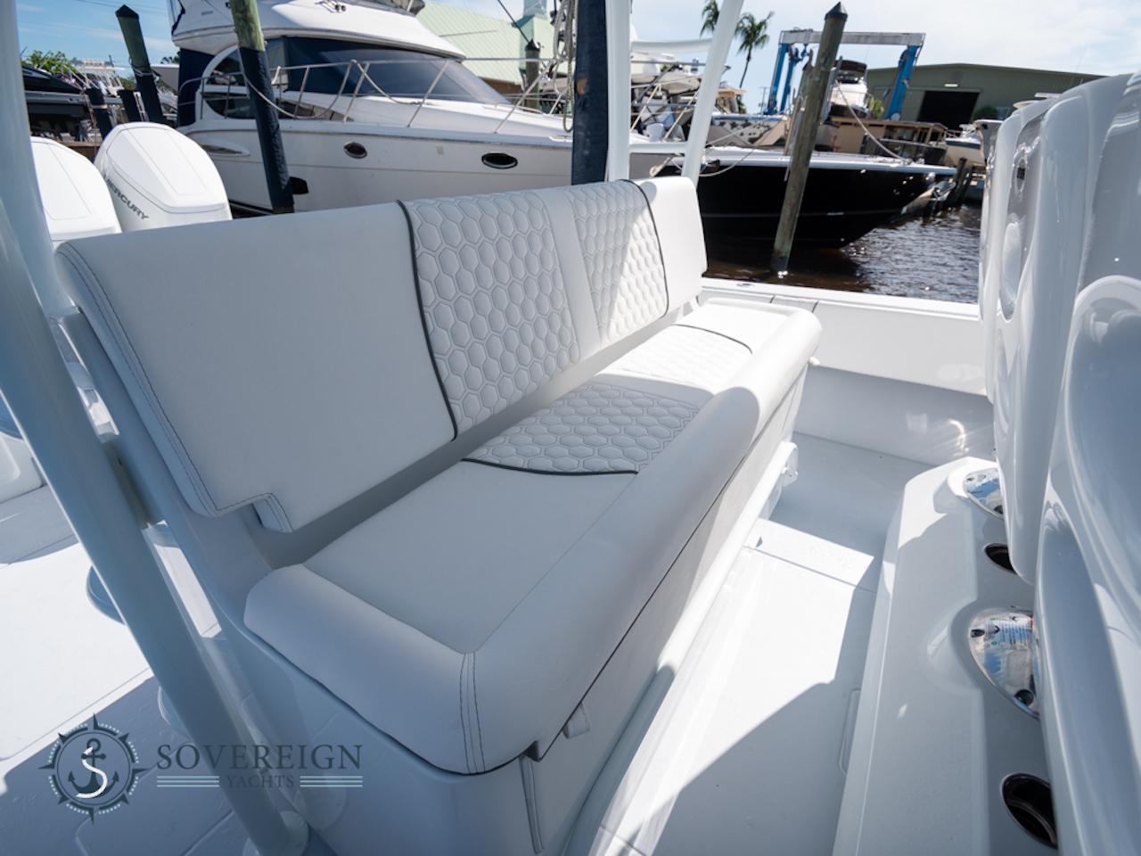 Contender-44 CB 2024-JDJ4C023C324 FL-US-2024 Contender 44 CB boat with luxurious white seating at a marina.-8992982 | Thumbnail