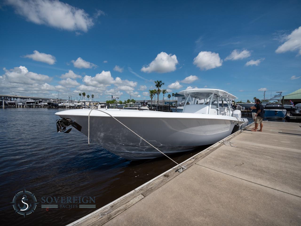 Contender-44 CB 2024-JDJ4C023C324 FL-US-2024 Contender 44 CB boat docked at a marina under a clear blue sky.-8992982 | Thumbnail