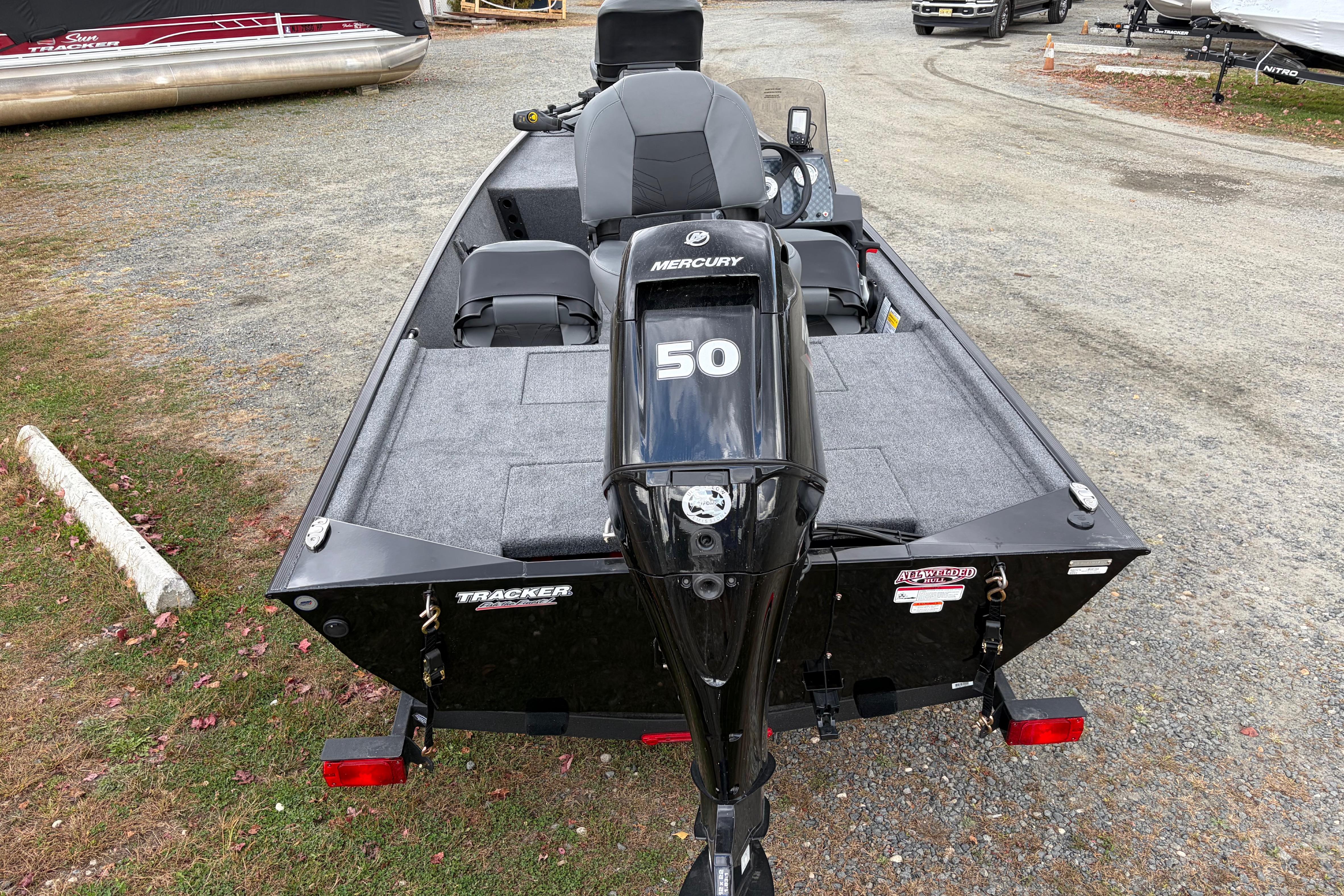 2026 Tracker Bass Tracker Classic XL boat with Mercury 50 engine, parked on gravel.