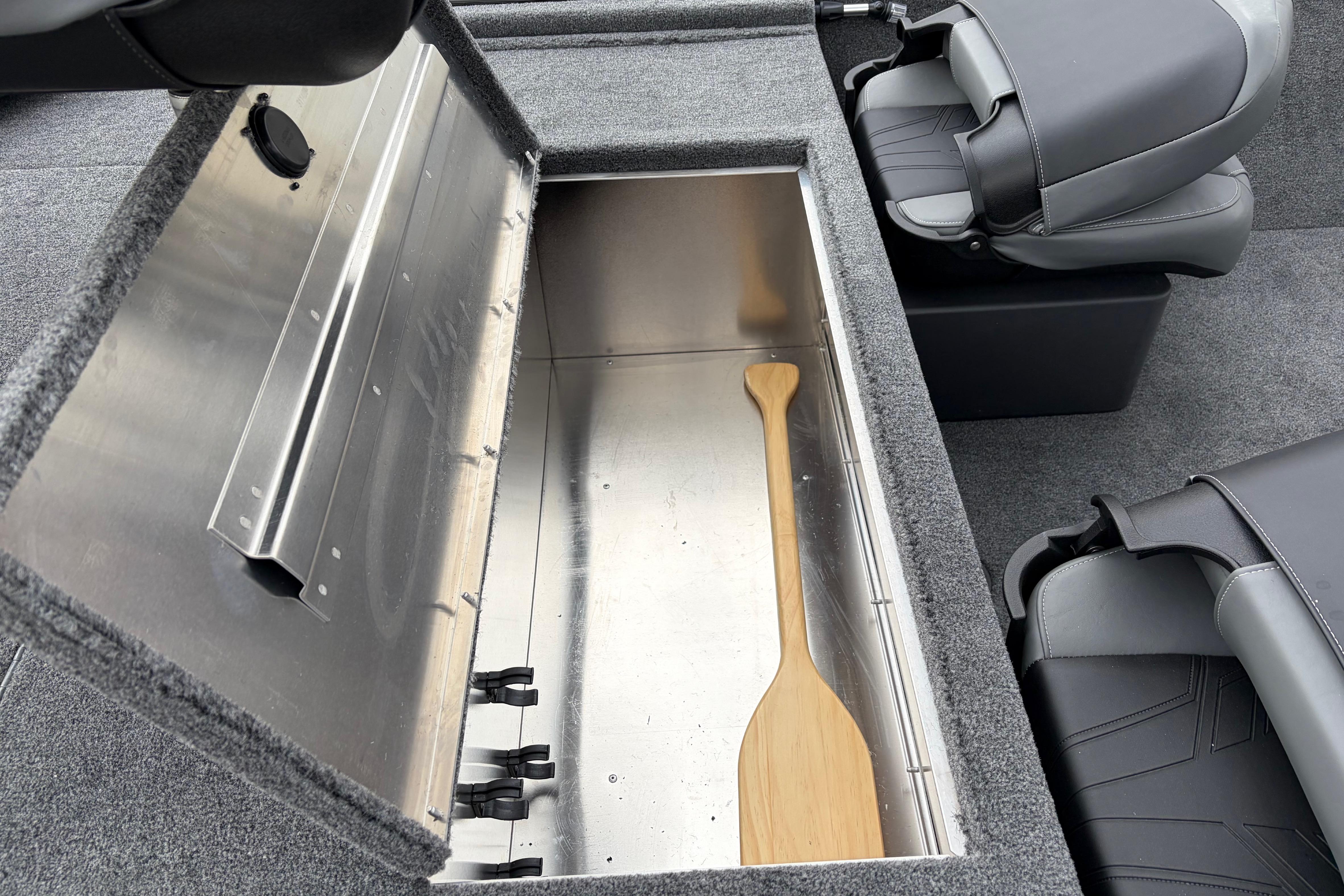 2026 Tracker Bass Tracker Classic XL boat storage compartment with wooden paddle.