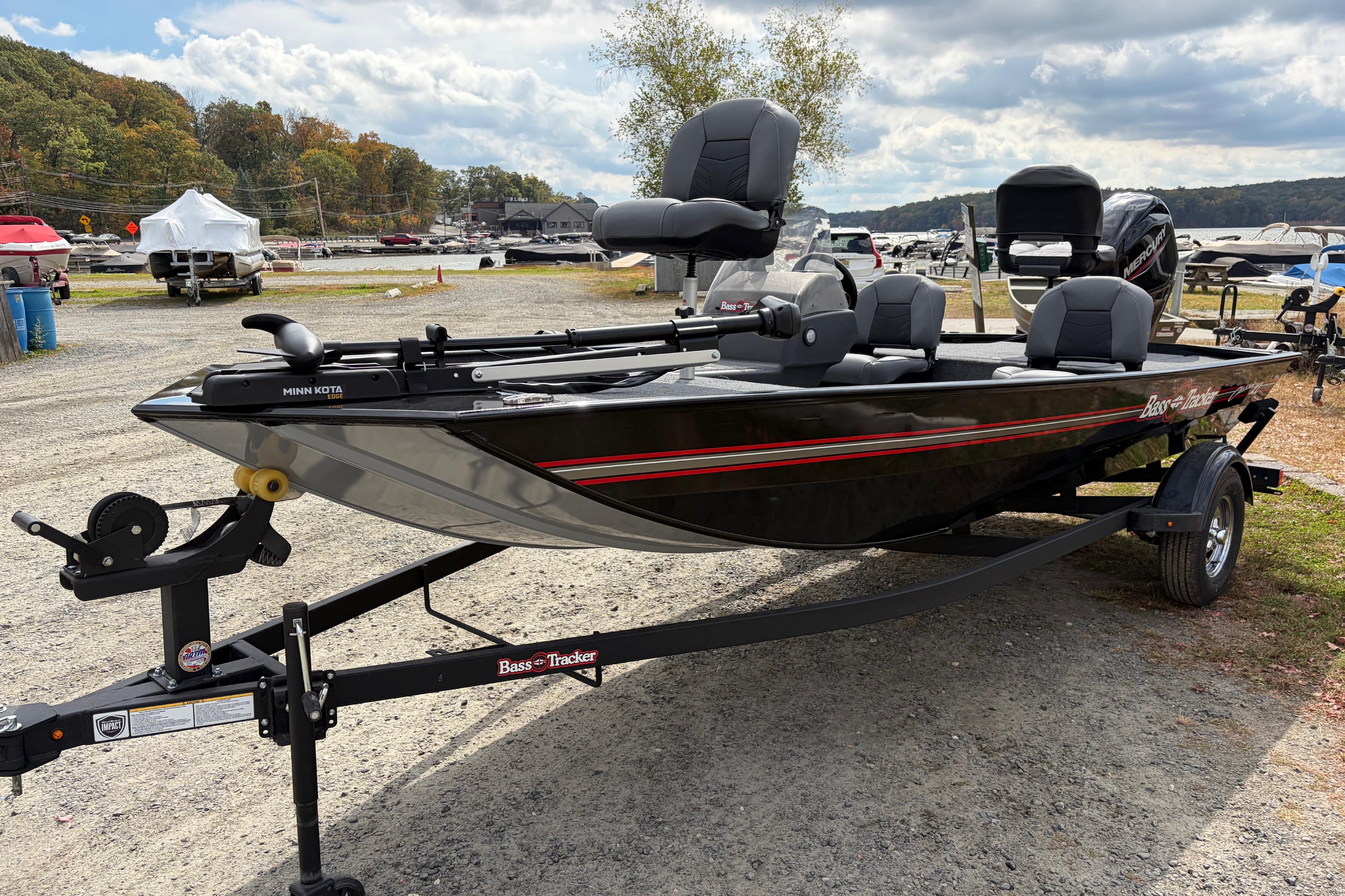 2026 Tracker Bass Tracker Classic XL boat on trailer, parked outdoors under cloudy sky.