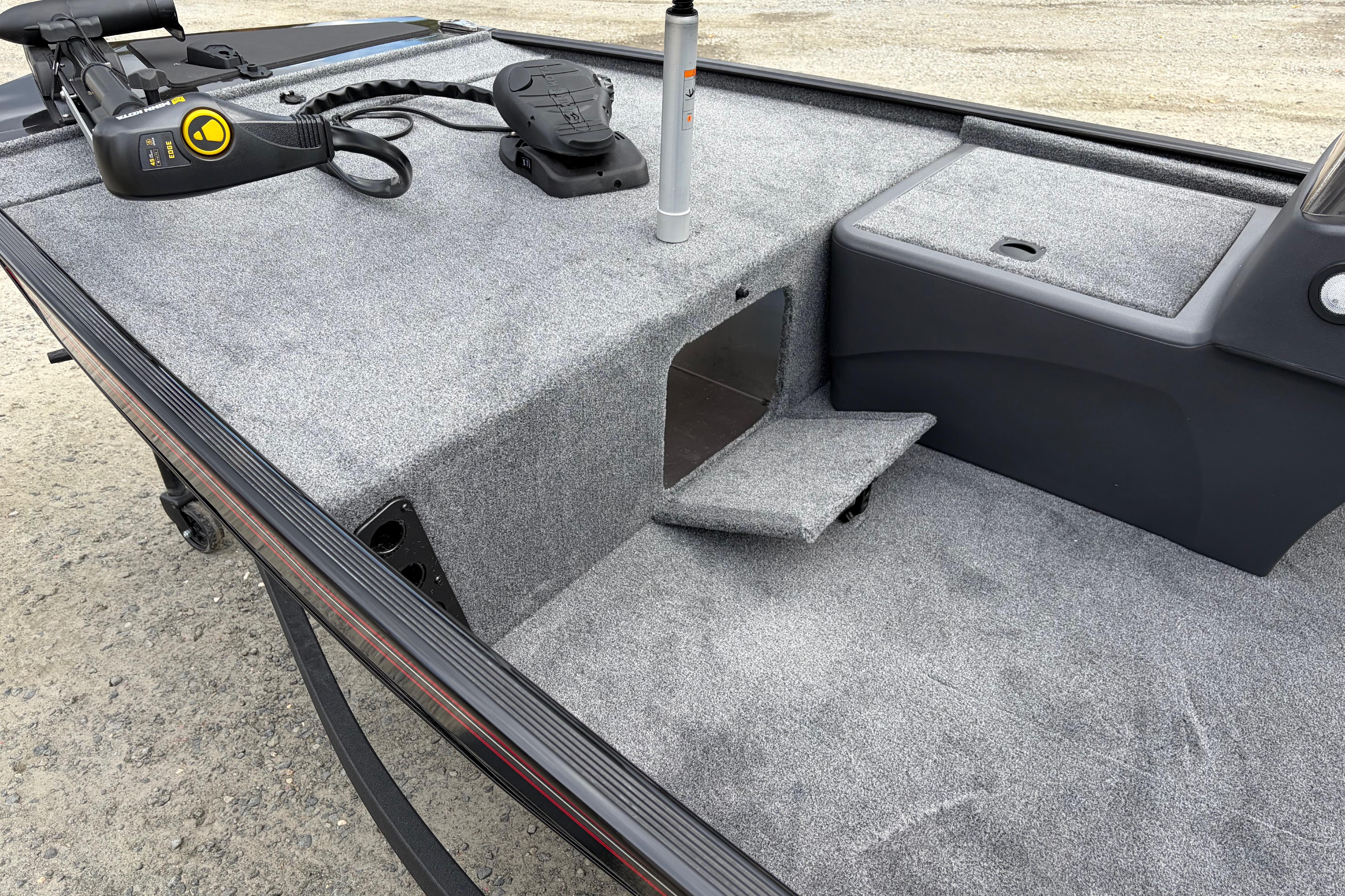 2026 Tracker Bass Tracker Classic XL boat interior with carpeted deck and storage compartment.