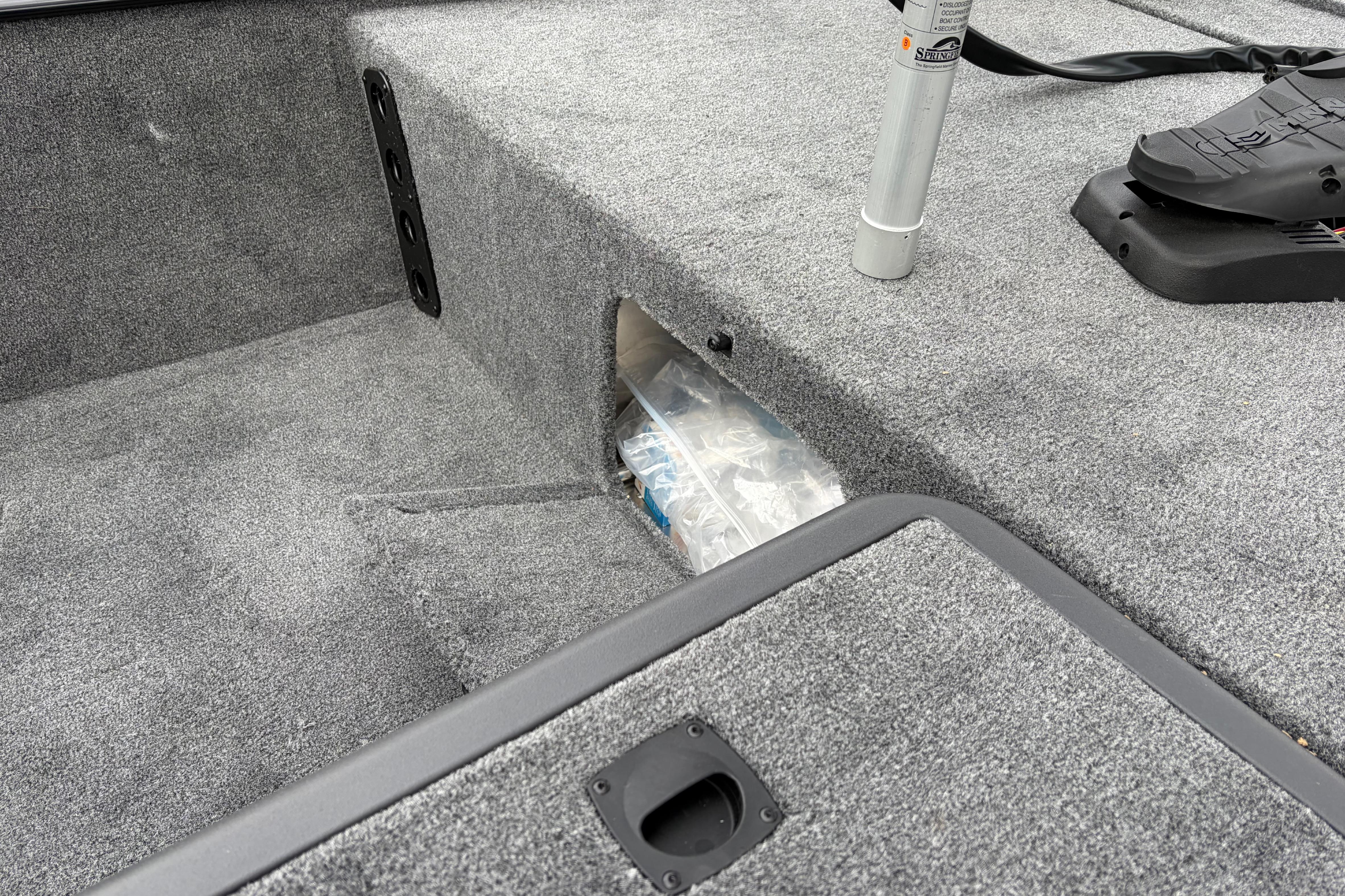 2026 Tracker Bass Tracker Classic XL boat interior with carpeted storage compartment.