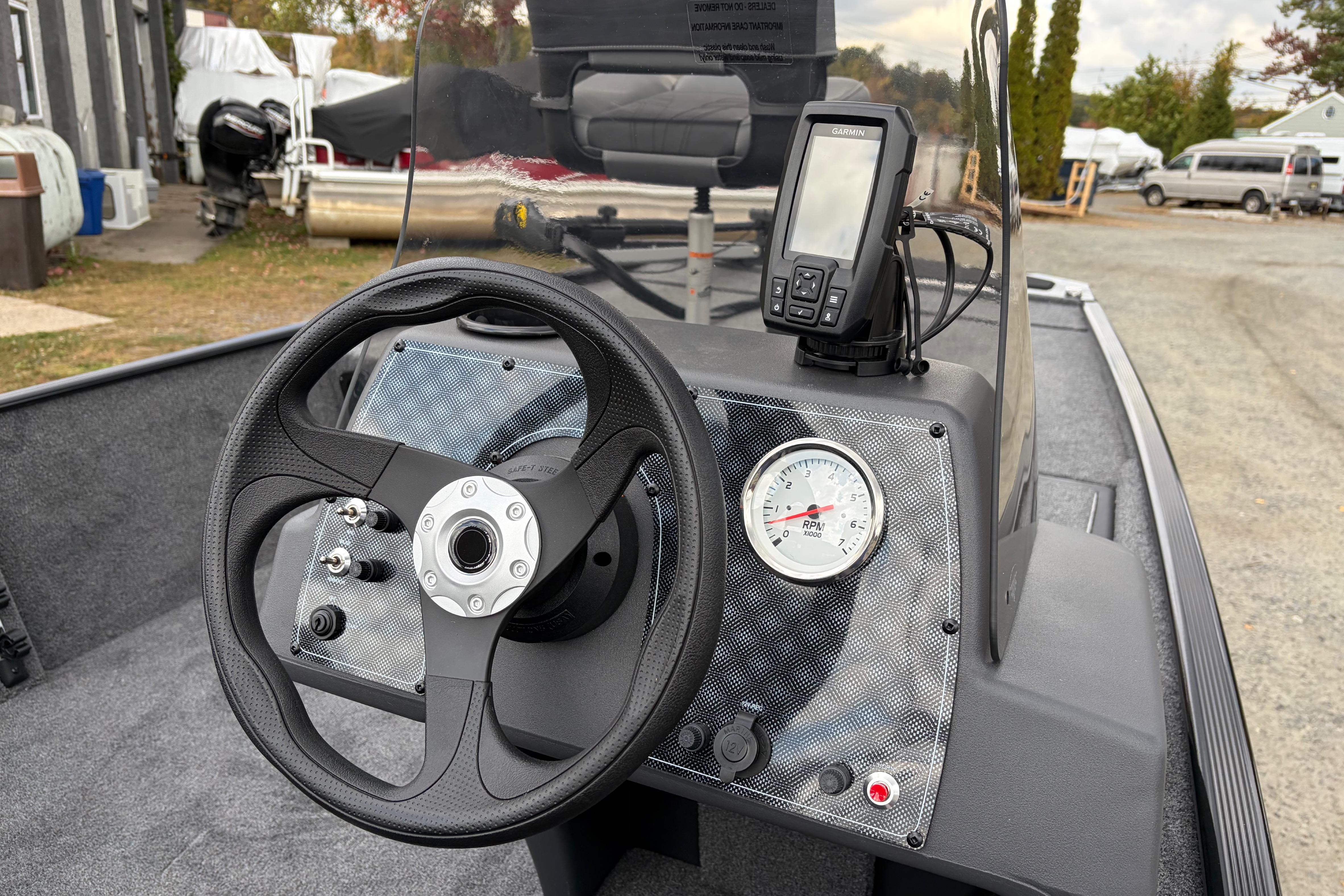 2026 Tracker Bass Tracker Classic XL dashboard with steering wheel and GPS device.