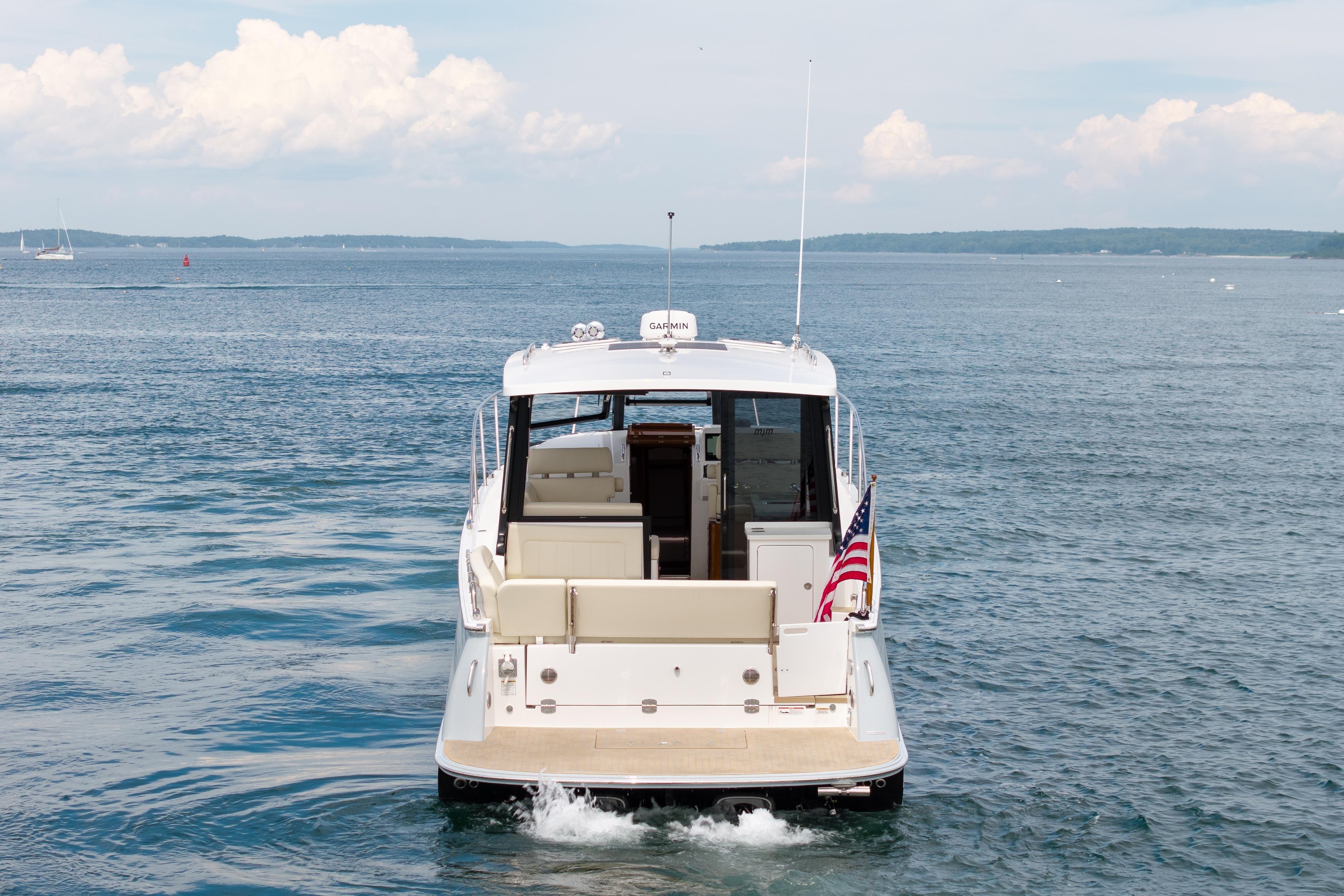 2025 MJM 42 yacht cruising on open water with American flag.