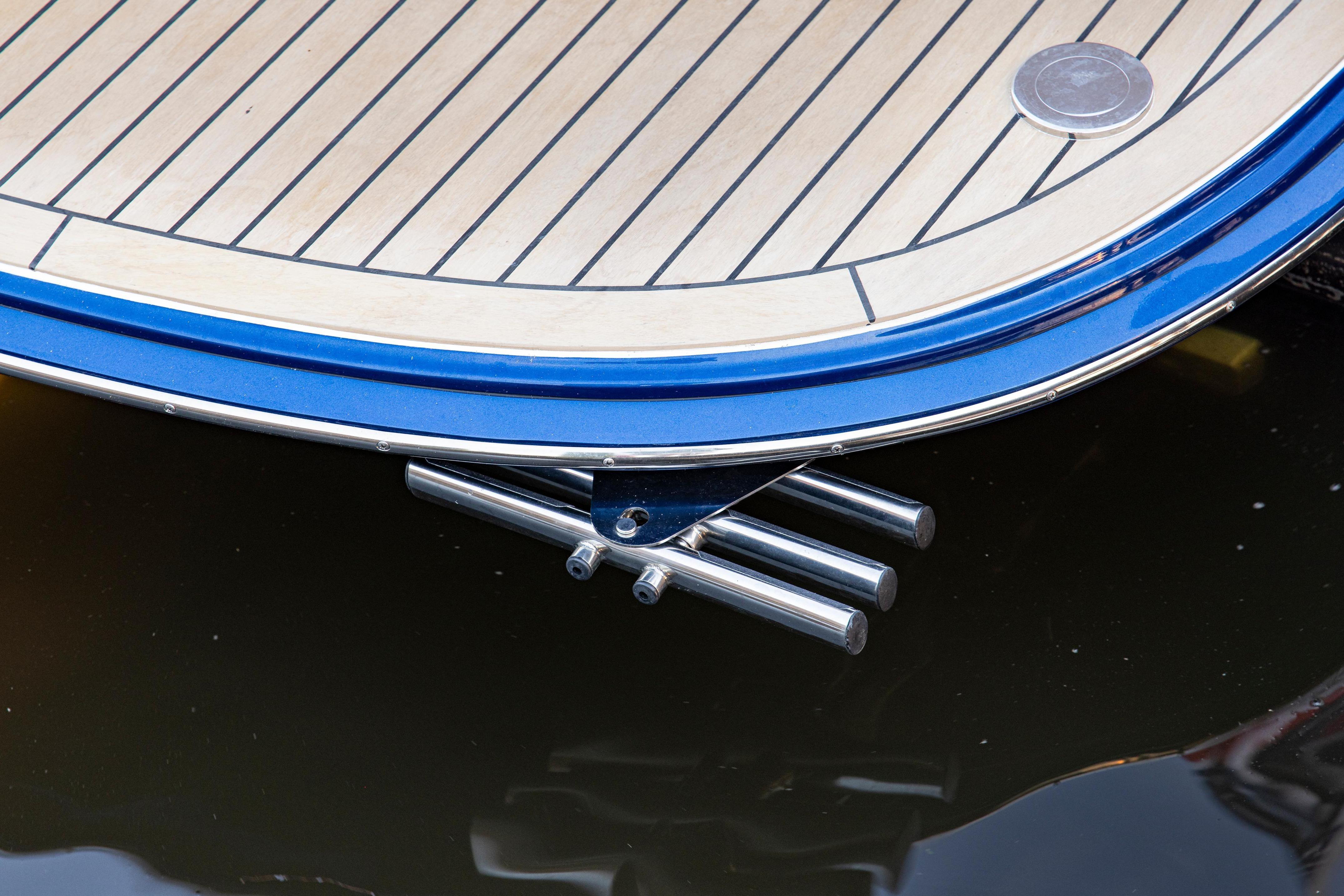 Sleek MJM 42 yacht stern detail, 2025 model, with polished metal fittings.