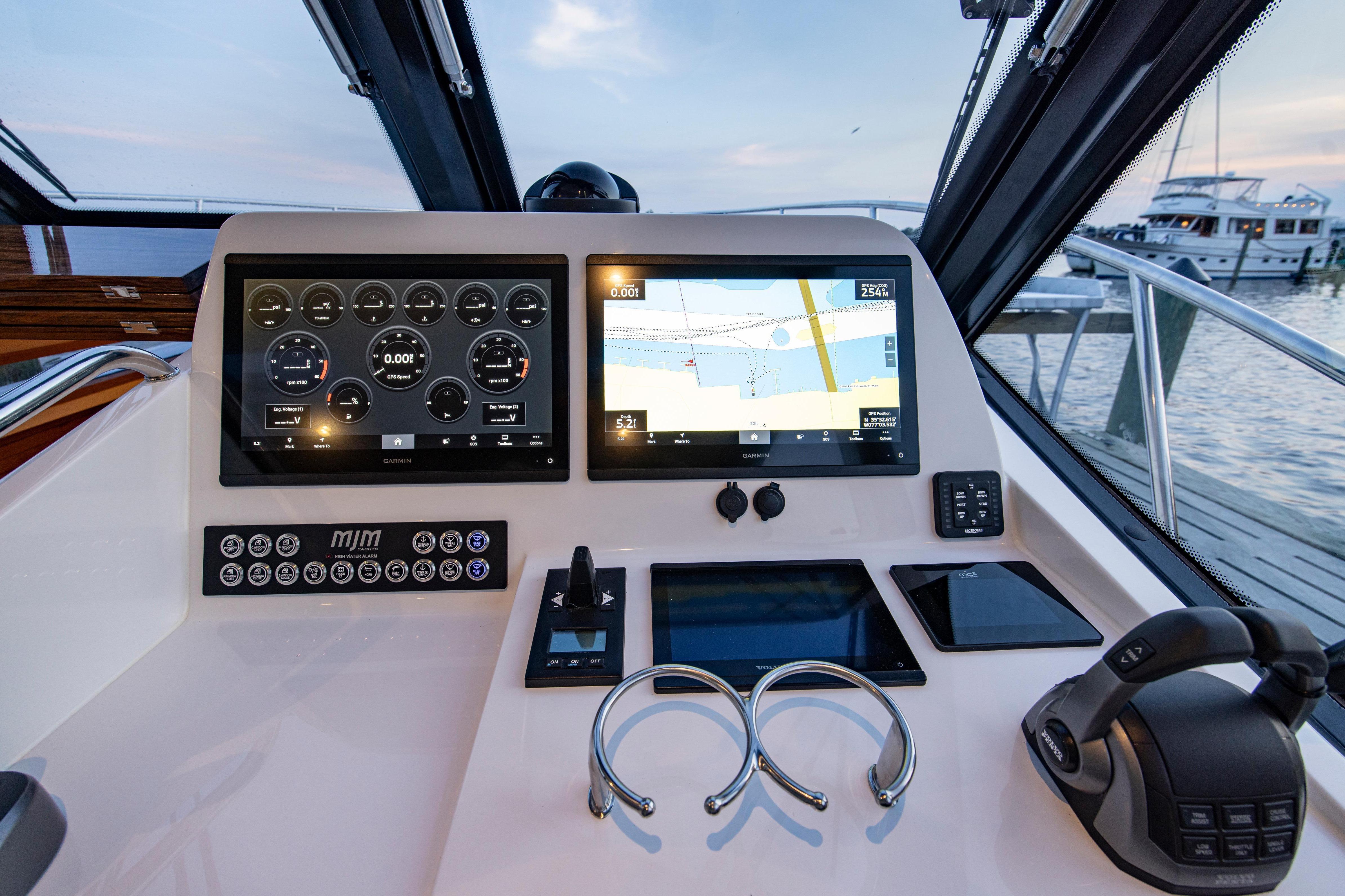 Helm of 2025 MJM 42 yacht with advanced navigation displays and controls.