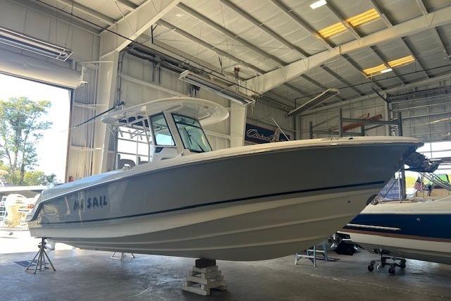 2017 Boston Whaler 280 Outrage boat in a warehouse, side view.