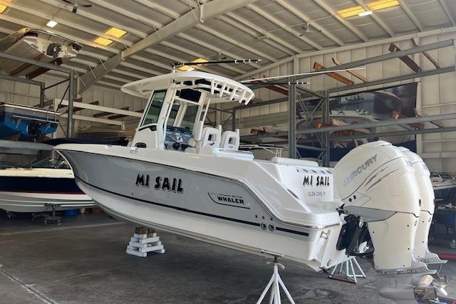 2017 Boston Whaler 280 Outrage boat in storage, featuring dual Mercury engines.