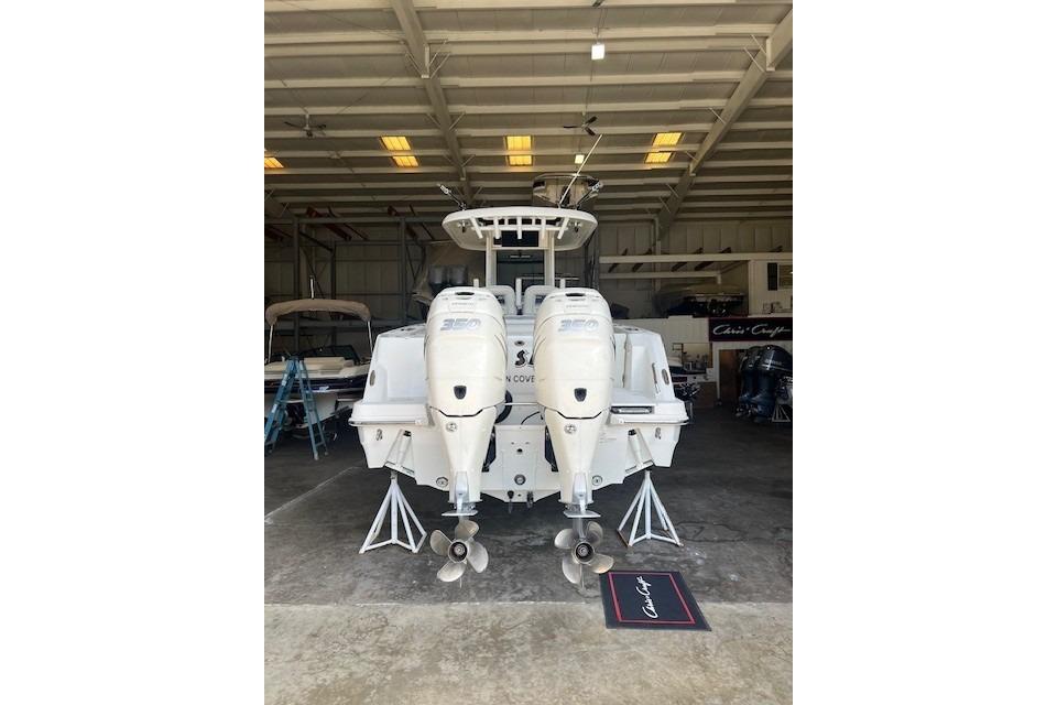 2017 Boston Whaler 280 Outrage in a garage, showcasing dual outboard engines.