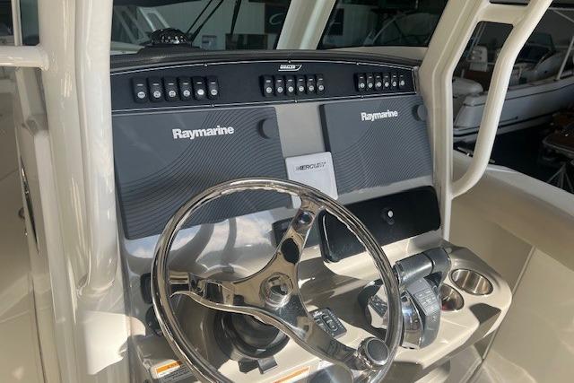 2017 Boston Whaler 280 Outrage helm with Raymarine electronics and steering wheel.