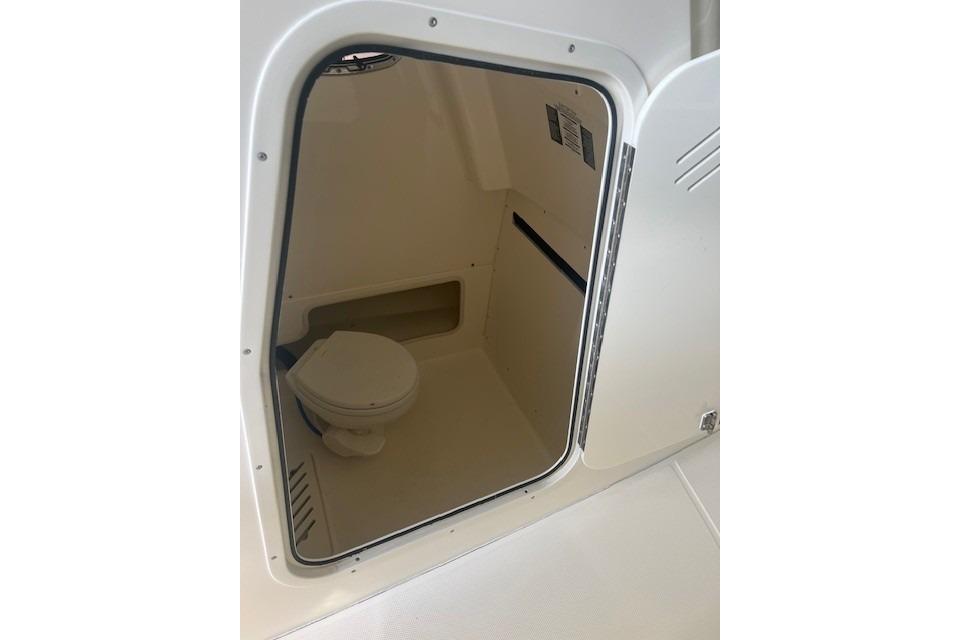 Interior view of 2017 Boston Whaler 280 Outrage boat's compact bathroom.