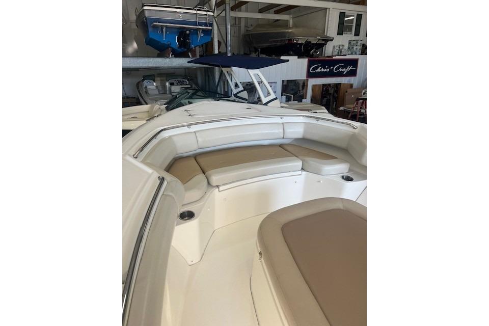 2017 Boston Whaler 280 Outrage boat interior with cushioned seating in a showroom.