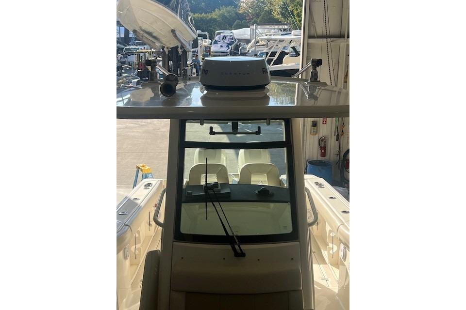 2017 Boston Whaler 280 Outrage boat in storage, showcasing helm and seating area.