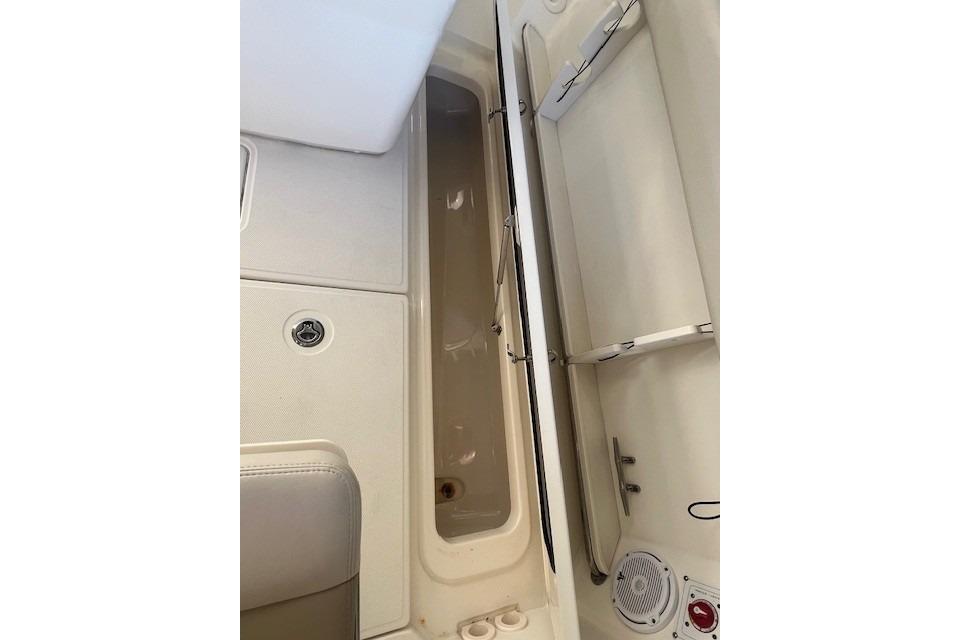 2017 Boston Whaler 280 Outrage interior storage compartment with seating and speaker.