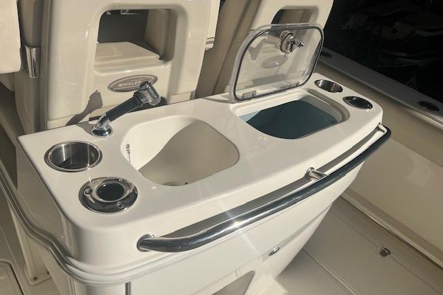2017 Boston Whaler 280 Outrage boat interior with sink and storage compartments.