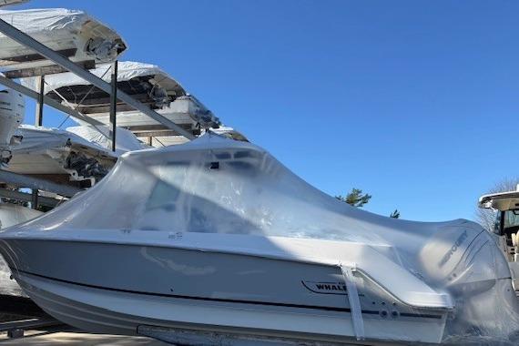 2017 Boston Whaler 280 Outrage boat covered in protective wrap, stored outdoors.