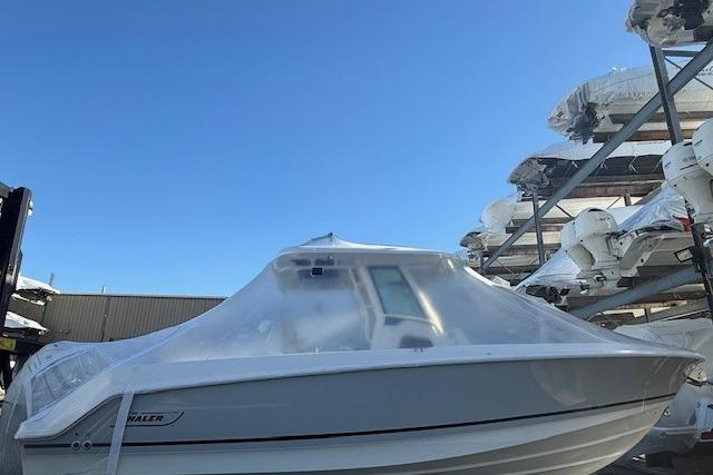 2017 Boston Whaler 280 Outrage boat covered in protective wrap, stored outdoors.