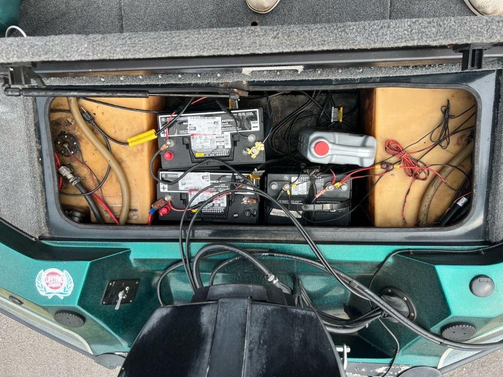 Battery compartment of a 1999 Sprint 286 Pro boat with wiring and components.