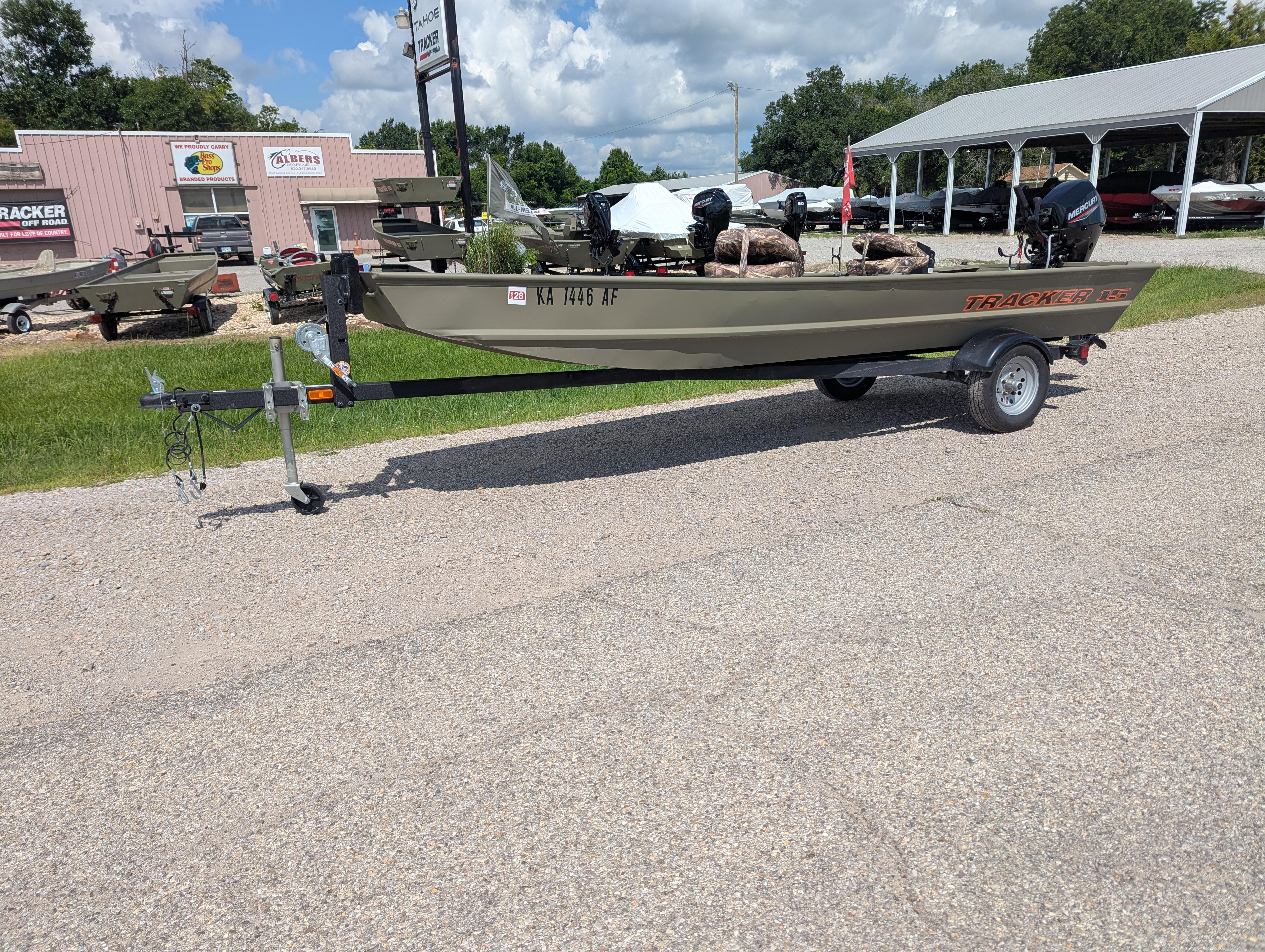 2025 Tracker Grizzly 15 Jon boat on trailer, parked outdoors near dealership.