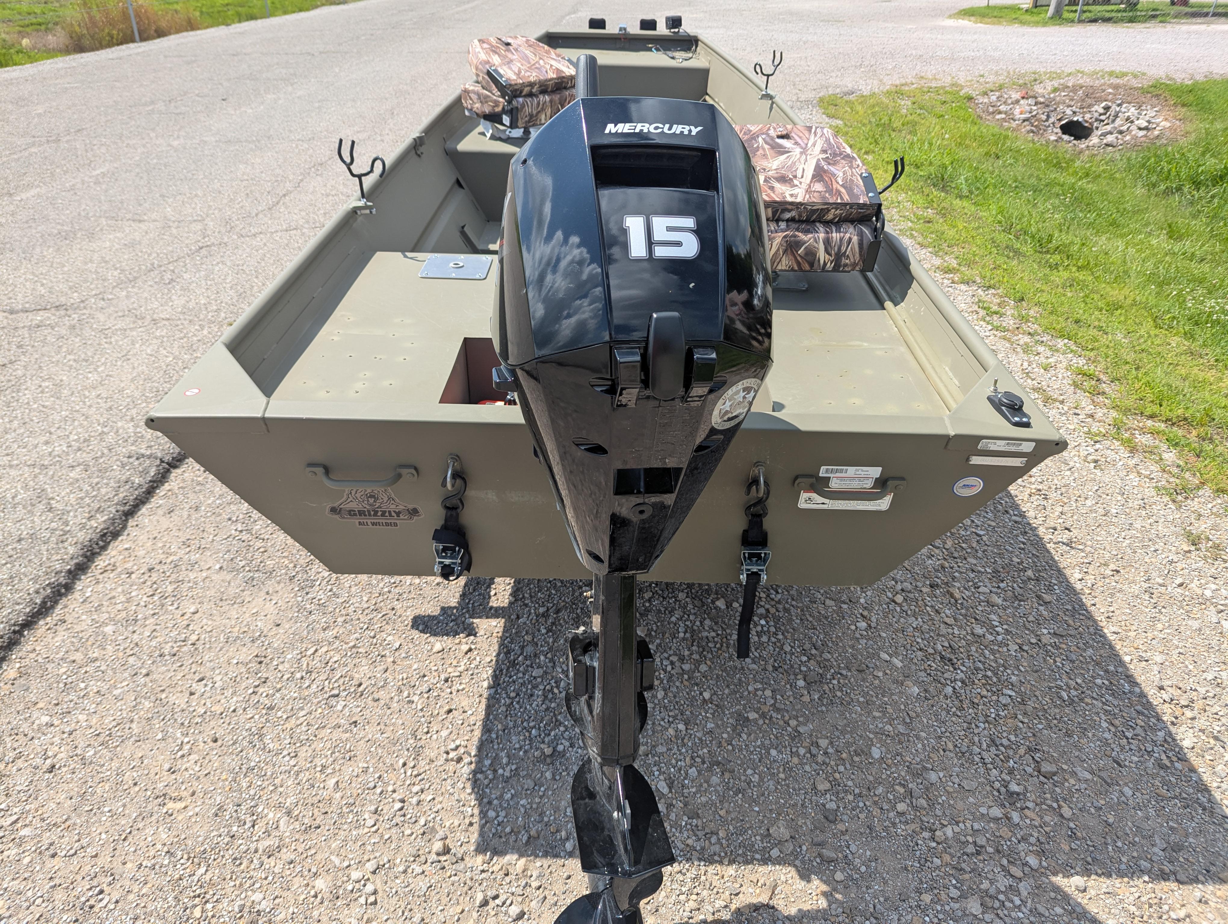 2025 Tracker Grizzly 15 Jon boat with Mercury 15 outboard motor on gravel road.
