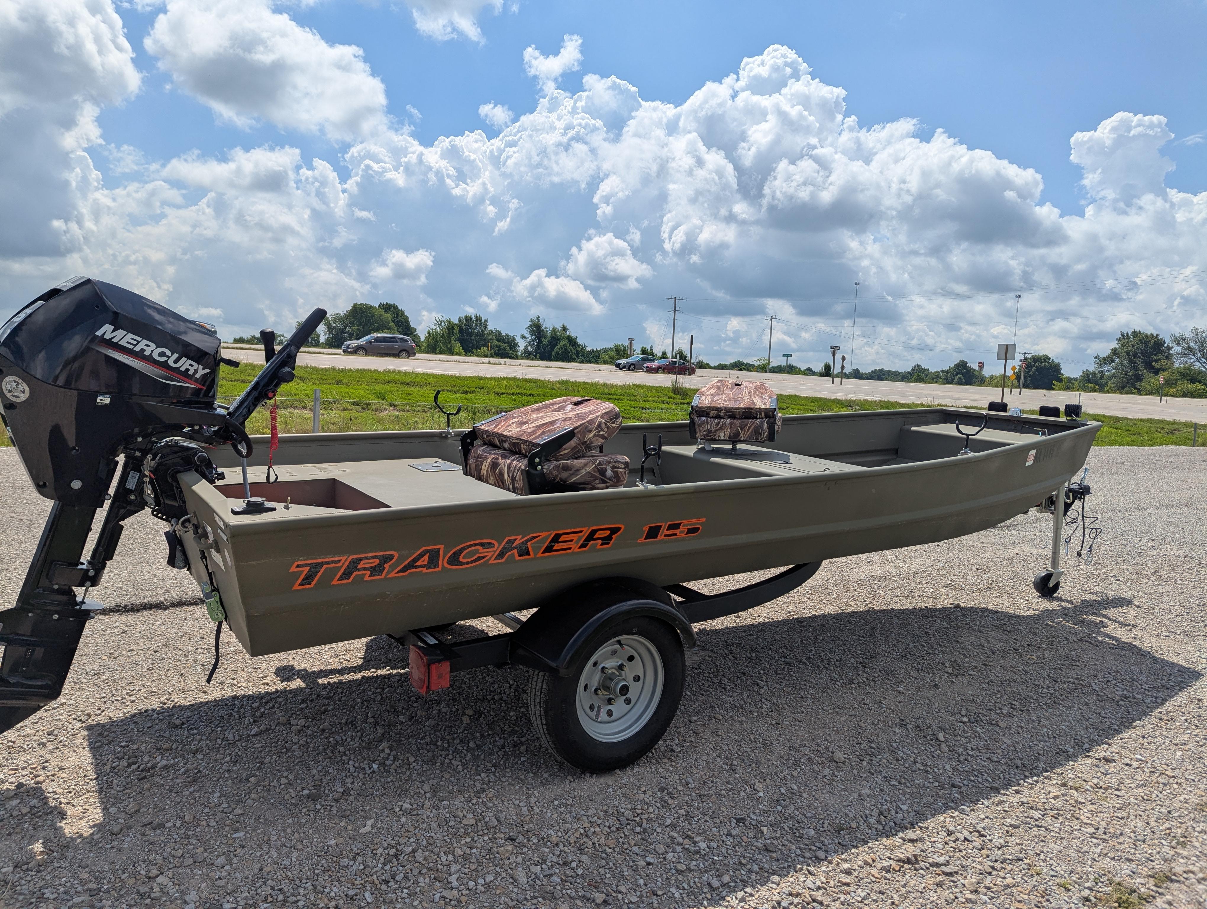 2025 Tracker Grizzly 15 Jon boat with Mercury motor on trailer, under a cloudy sky.
