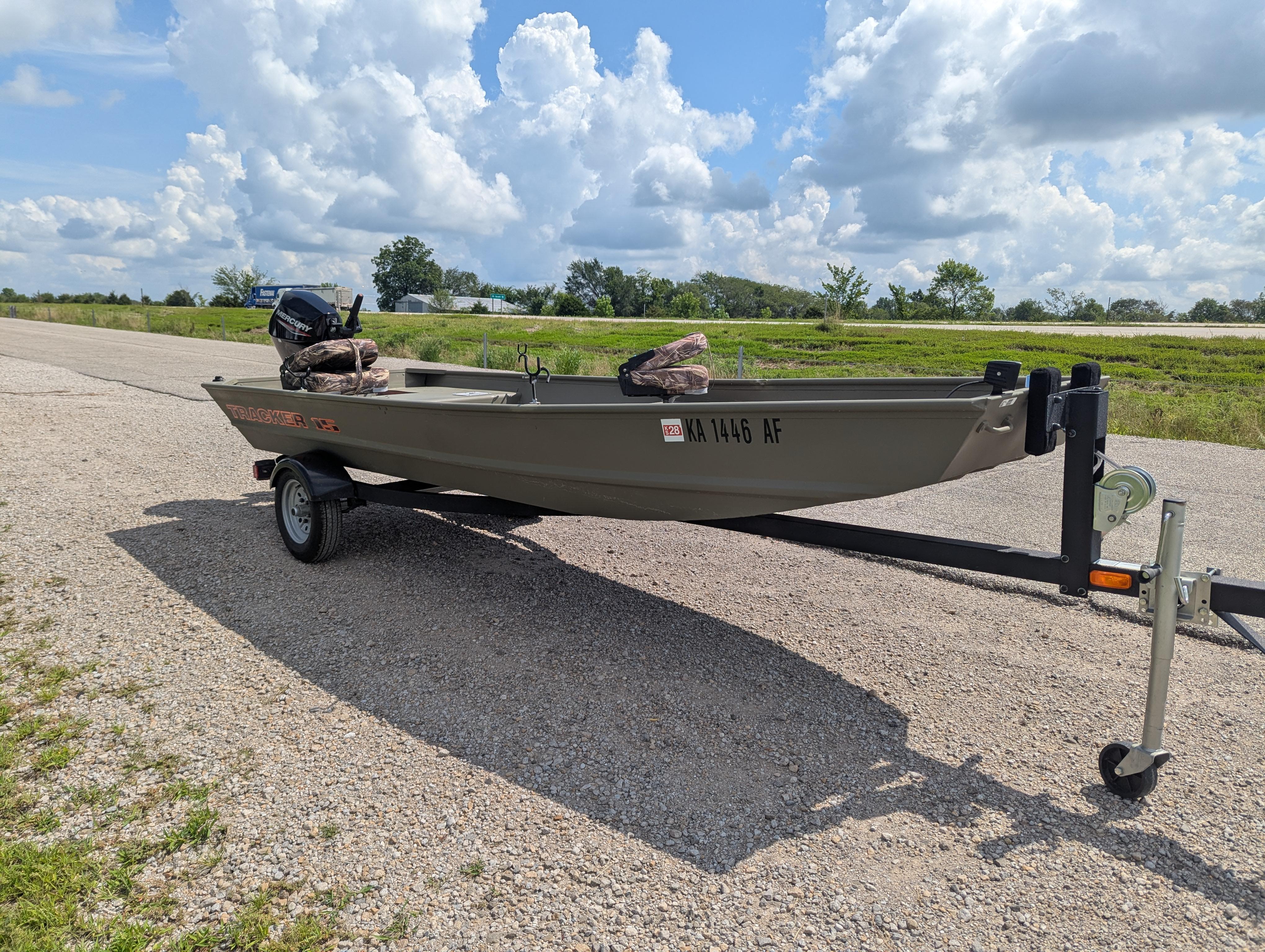2025 Tracker Grizzly 15 Jon boat on trailer under a cloudy sky.