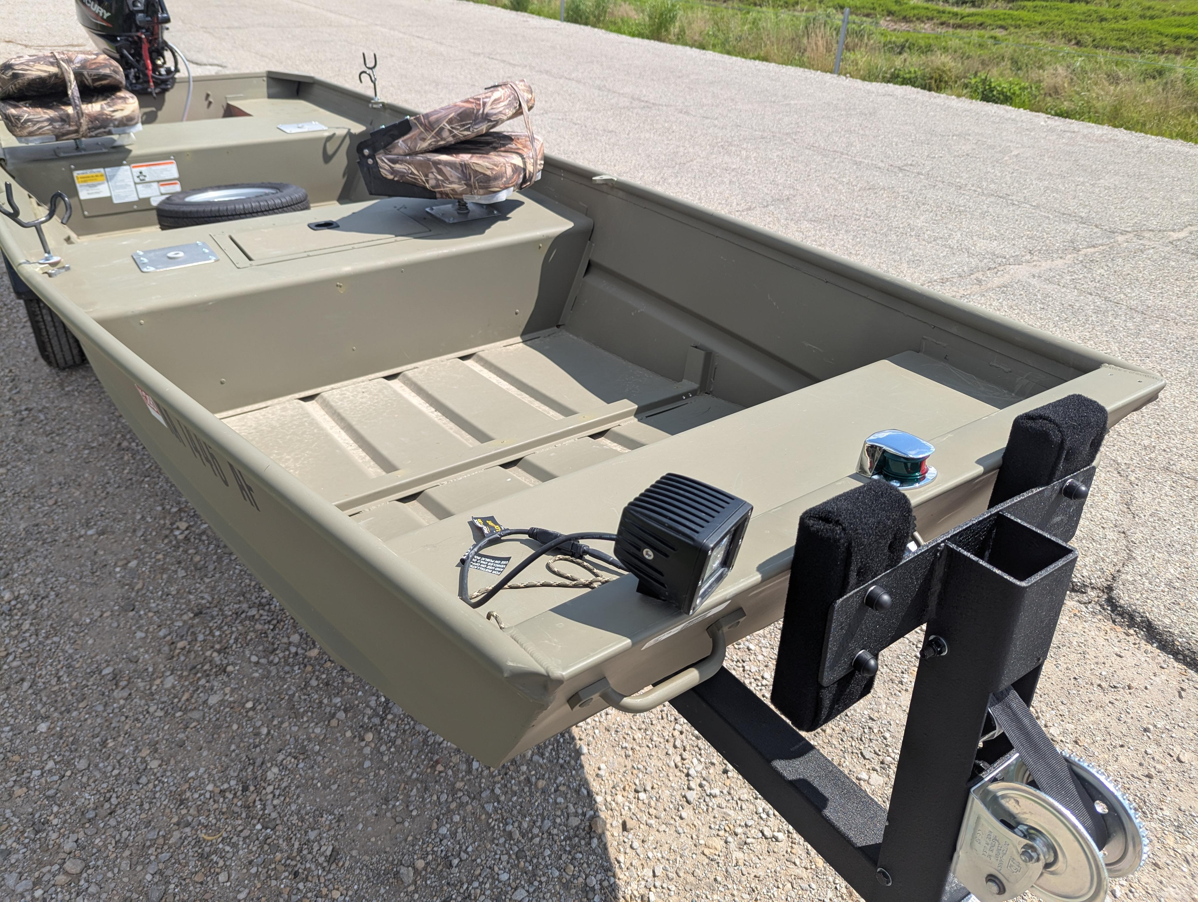 2025 Tracker Grizzly 15 Jon boat on trailer, parked on gravel road.